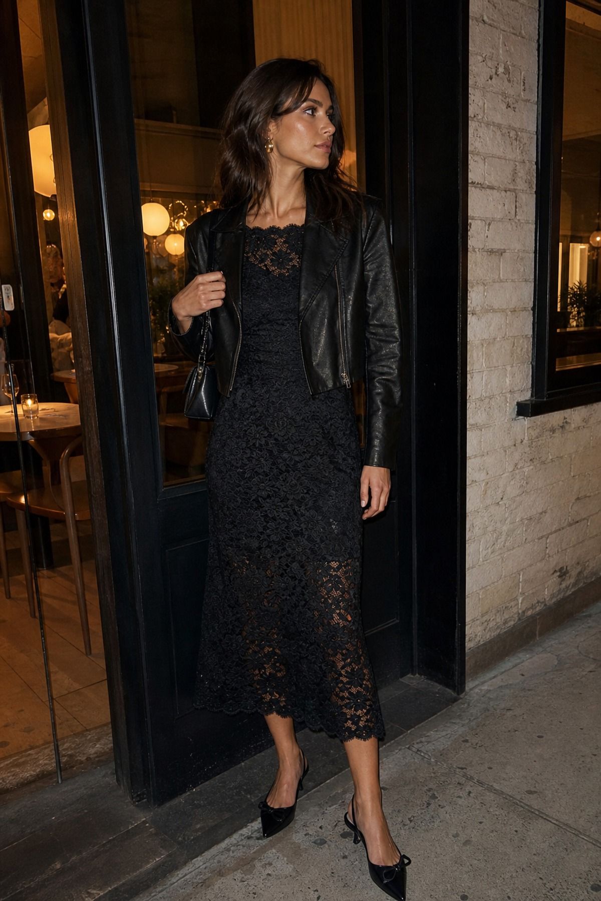 Woman wearing a black lace dress with a leather jacket