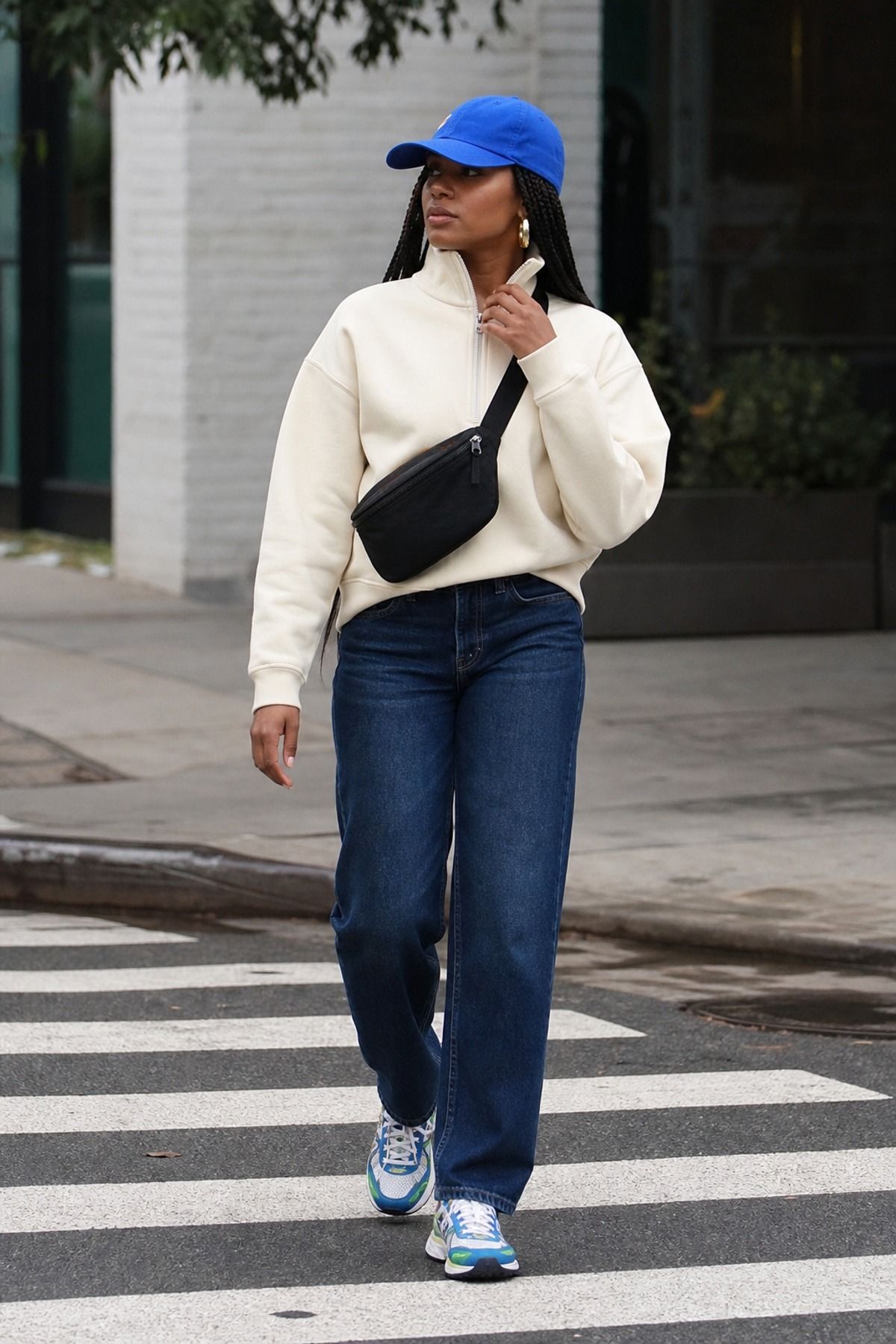 Woman wearing a half-zip sweatshirt with straight jeans, a midsize casual outfit