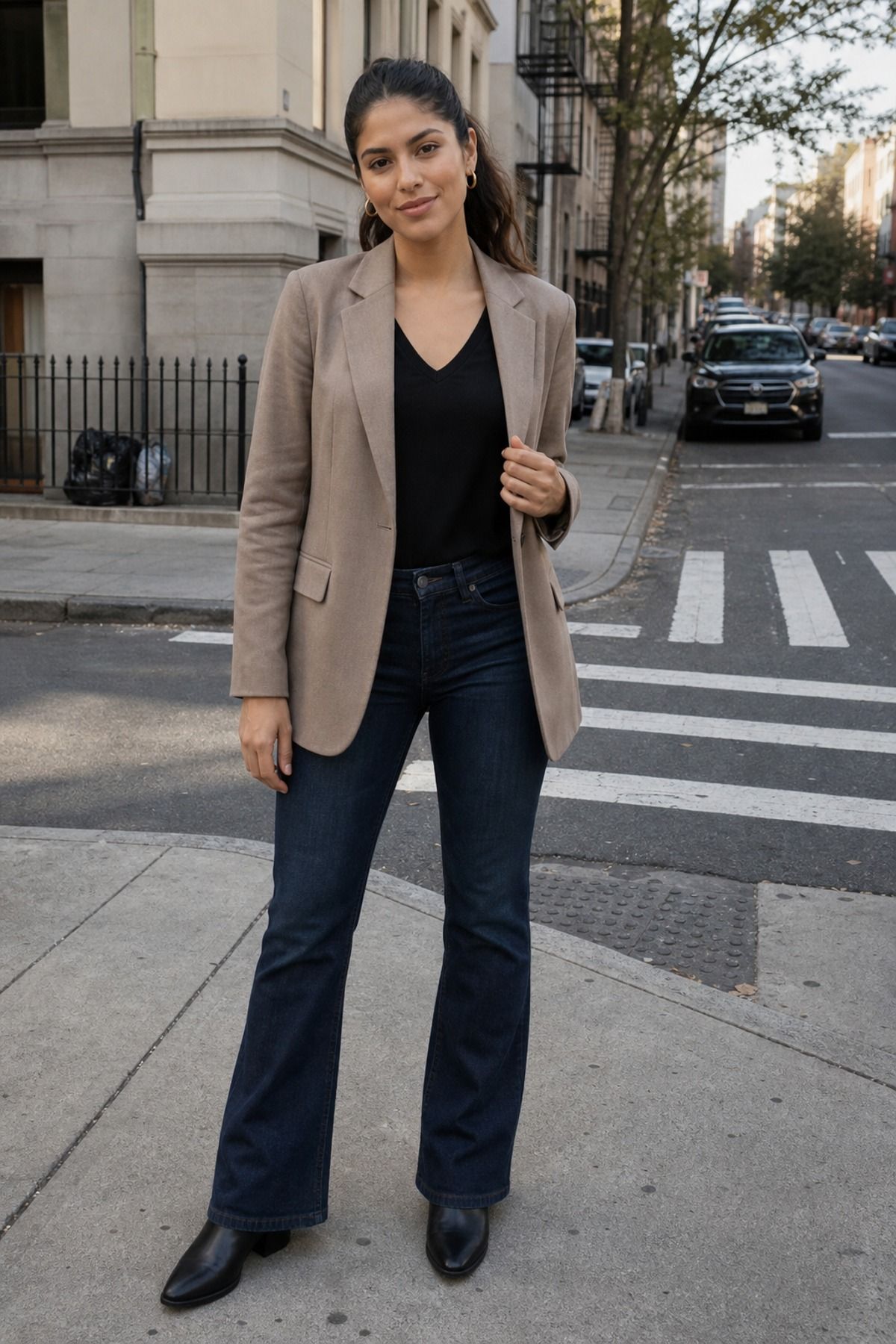 Woman wearing a hip-length blazer with bootcut jeans