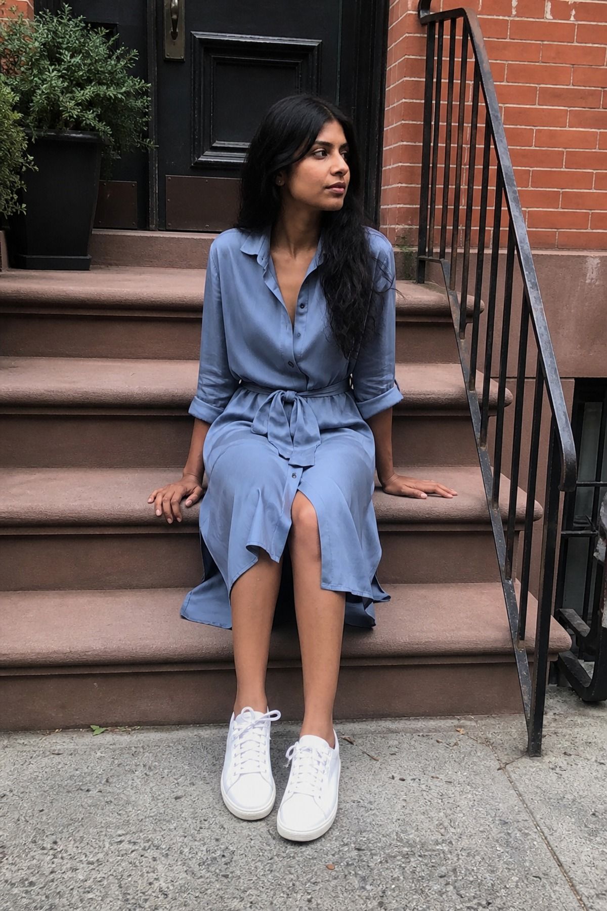 Woman wearing a soft shirt dress with a waist tie
