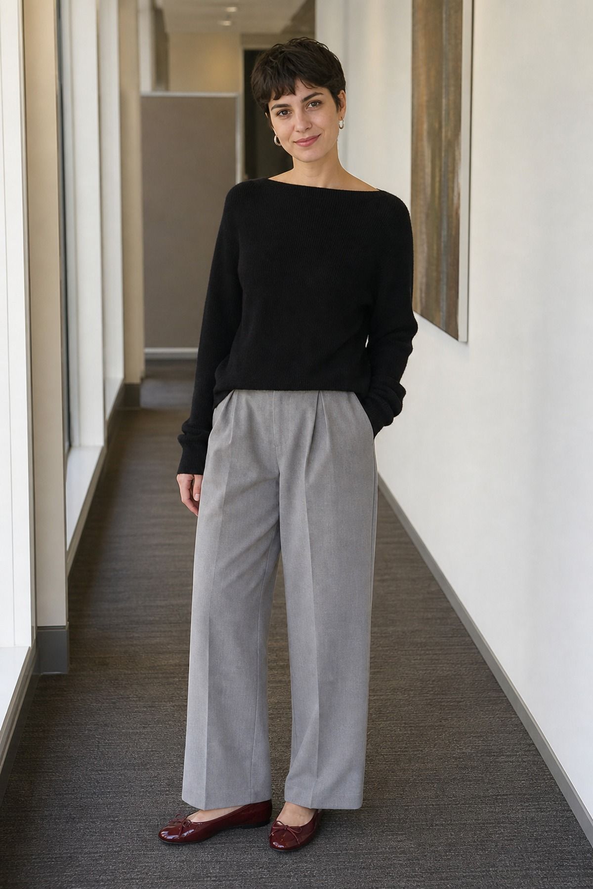 Woman wearing a boatneck sweater with wide trousers