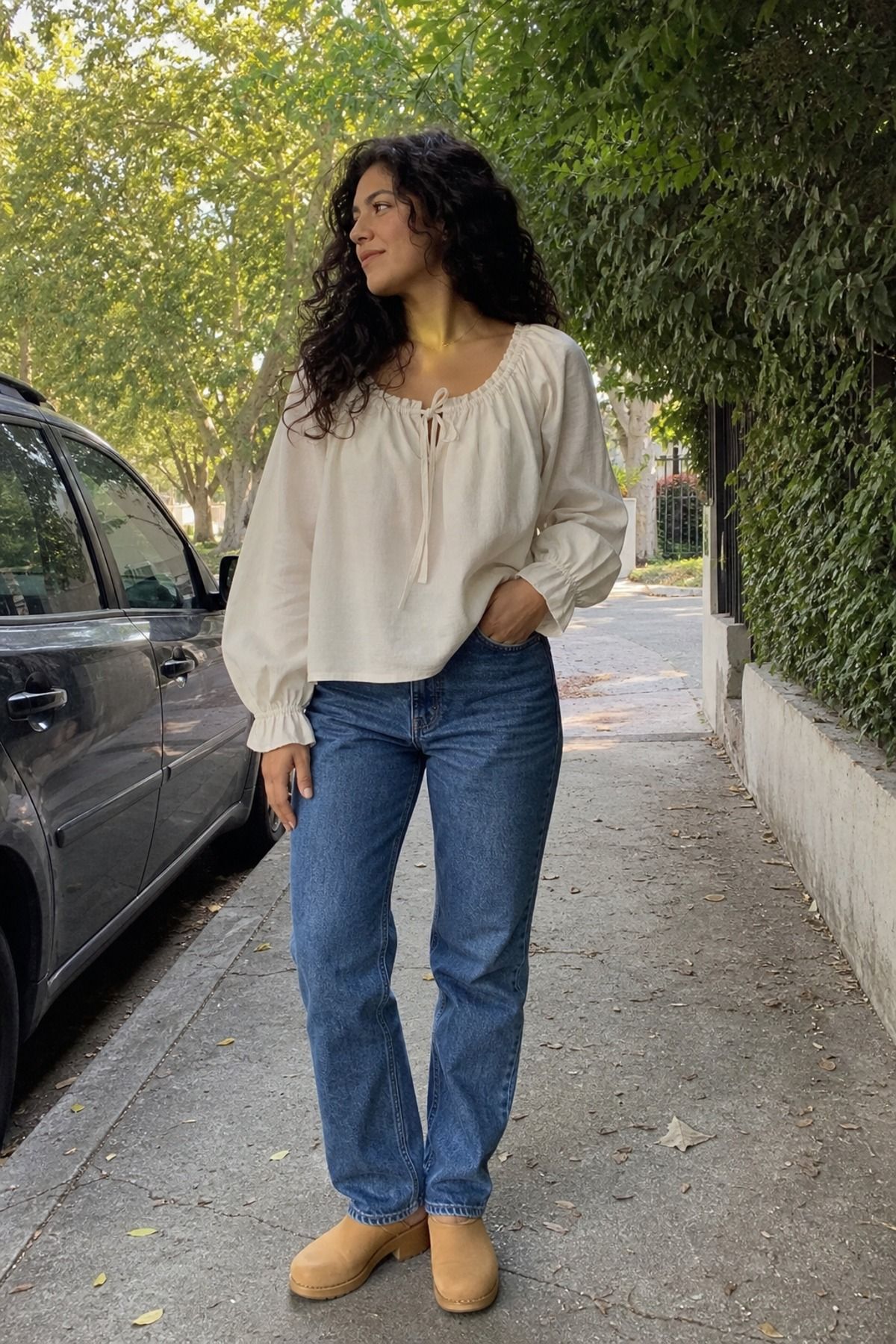 Woman wearing a peasant blouse with straight jeans