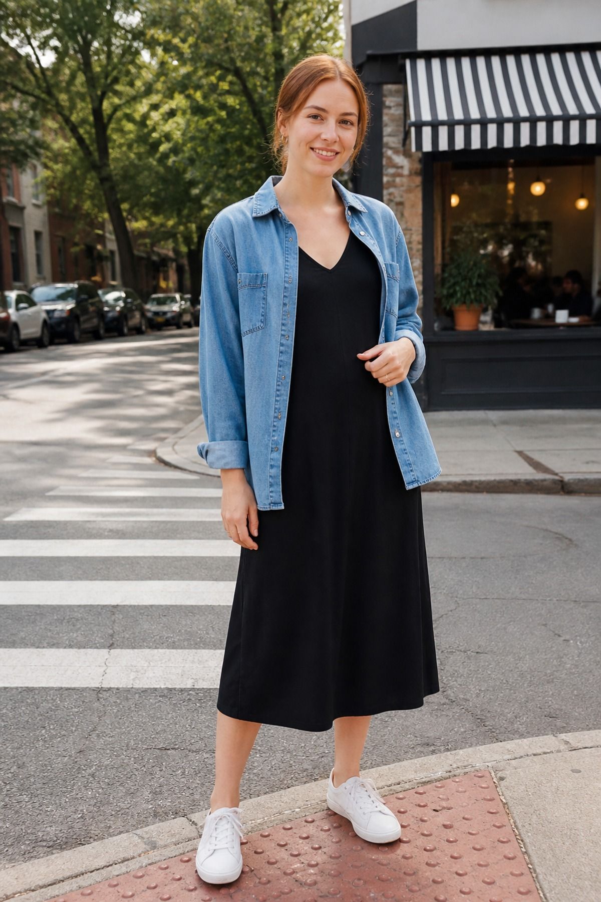 Woman wearing a v-neck dress with a denim shirt
