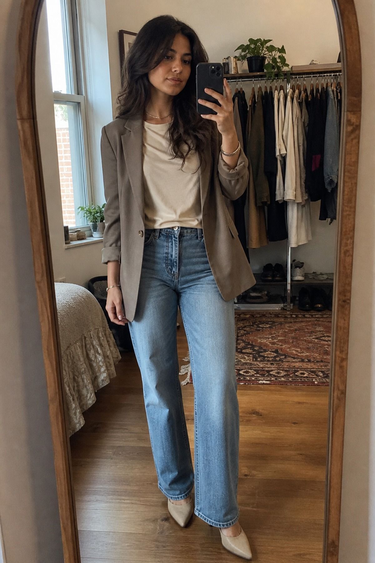 Woman wearing a draped tee with straight jeans and an open blazer