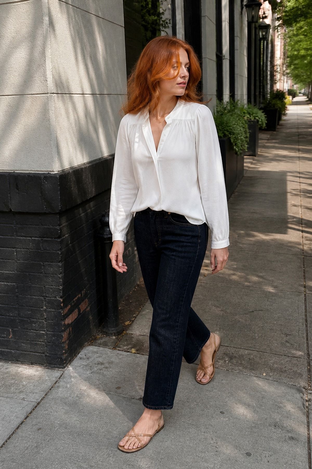 Woman wearing a popover blouse with dark straight denim