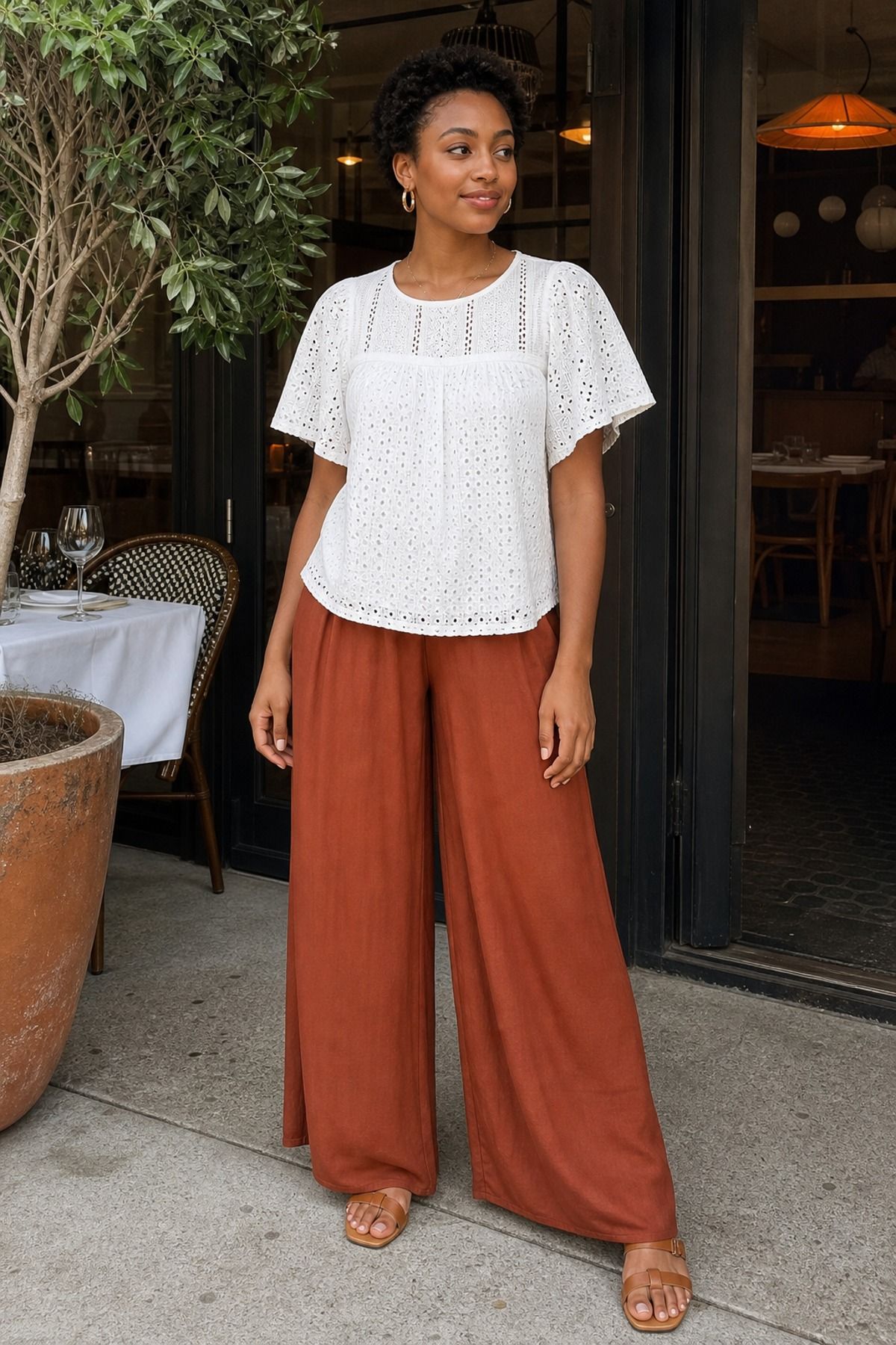 Woman wearing an eyelet top with soft palazzo pants