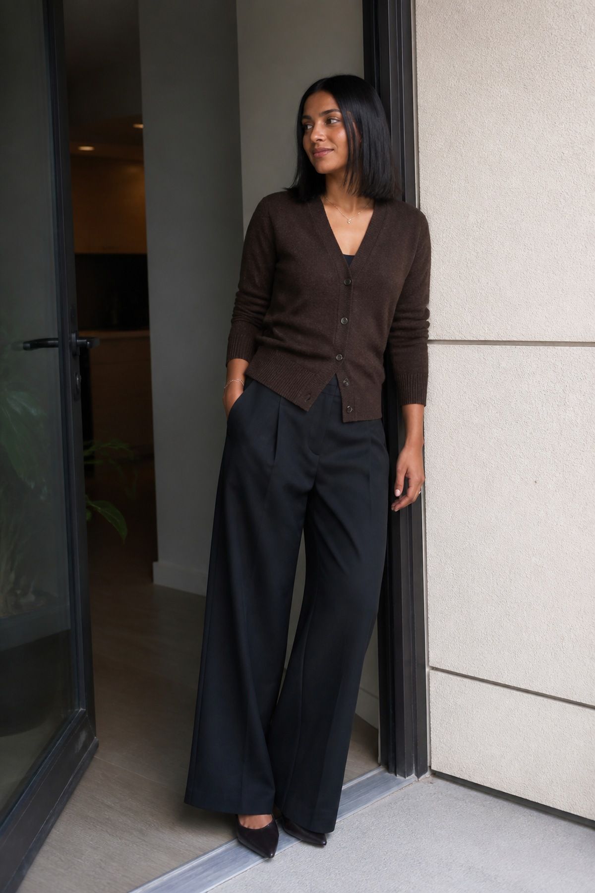 Woman wearing an espresso cardigan with black wide-leg pants, a black and brown outfit