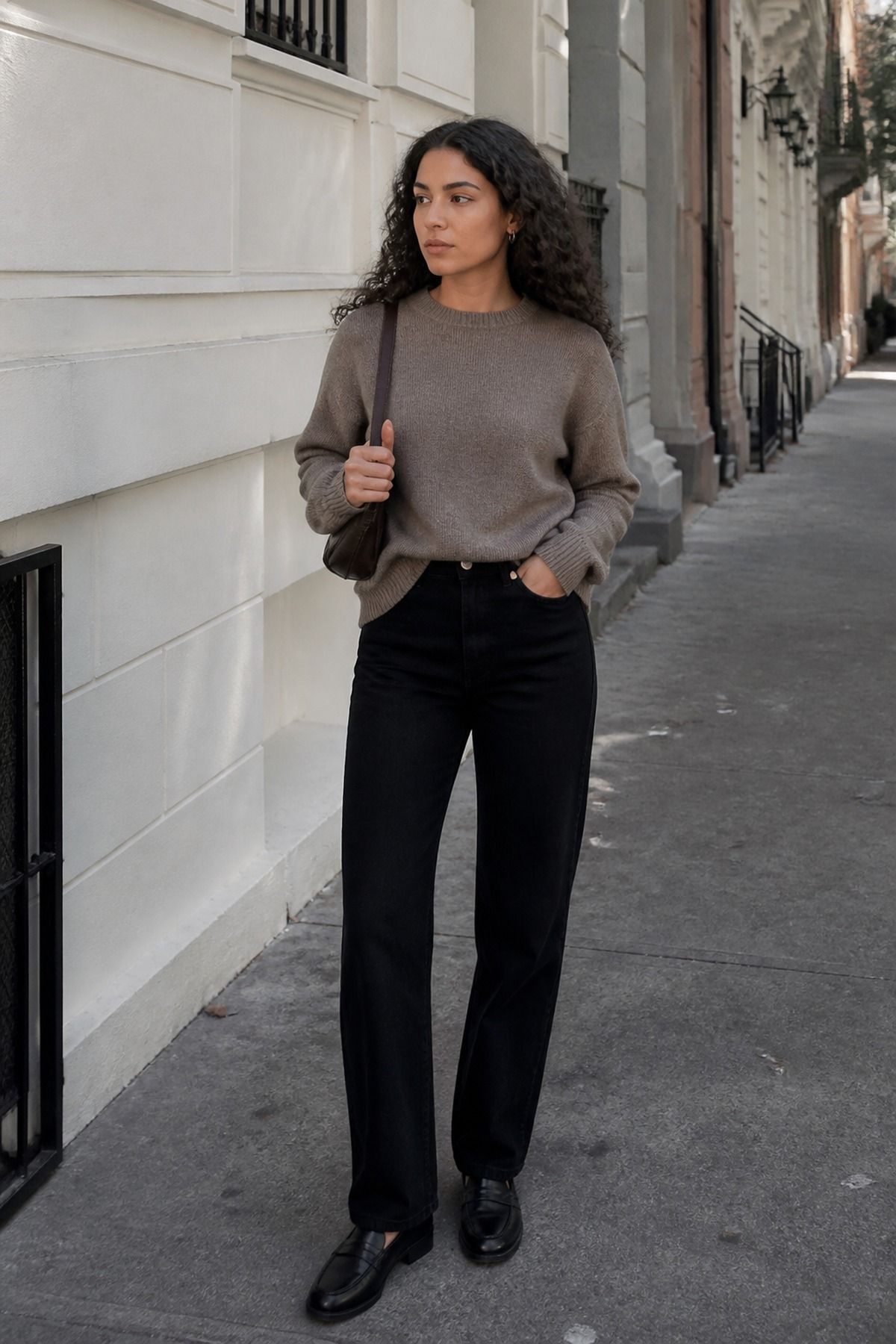 Woman wearing a taupe sweater with black jeans, a brown outfit