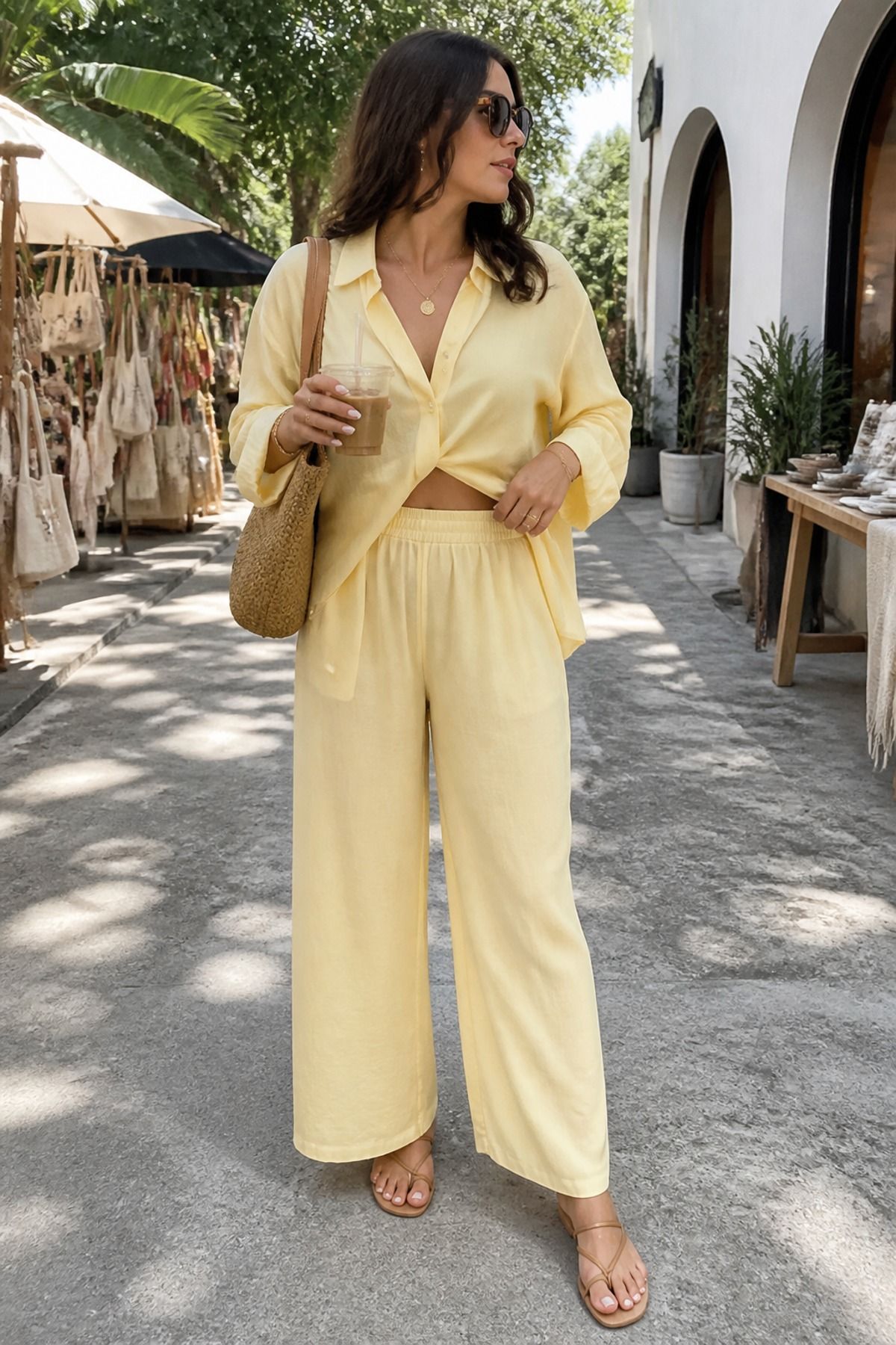Woman wearing a yellow matching set with minimal sandals, a butter yellow outfit