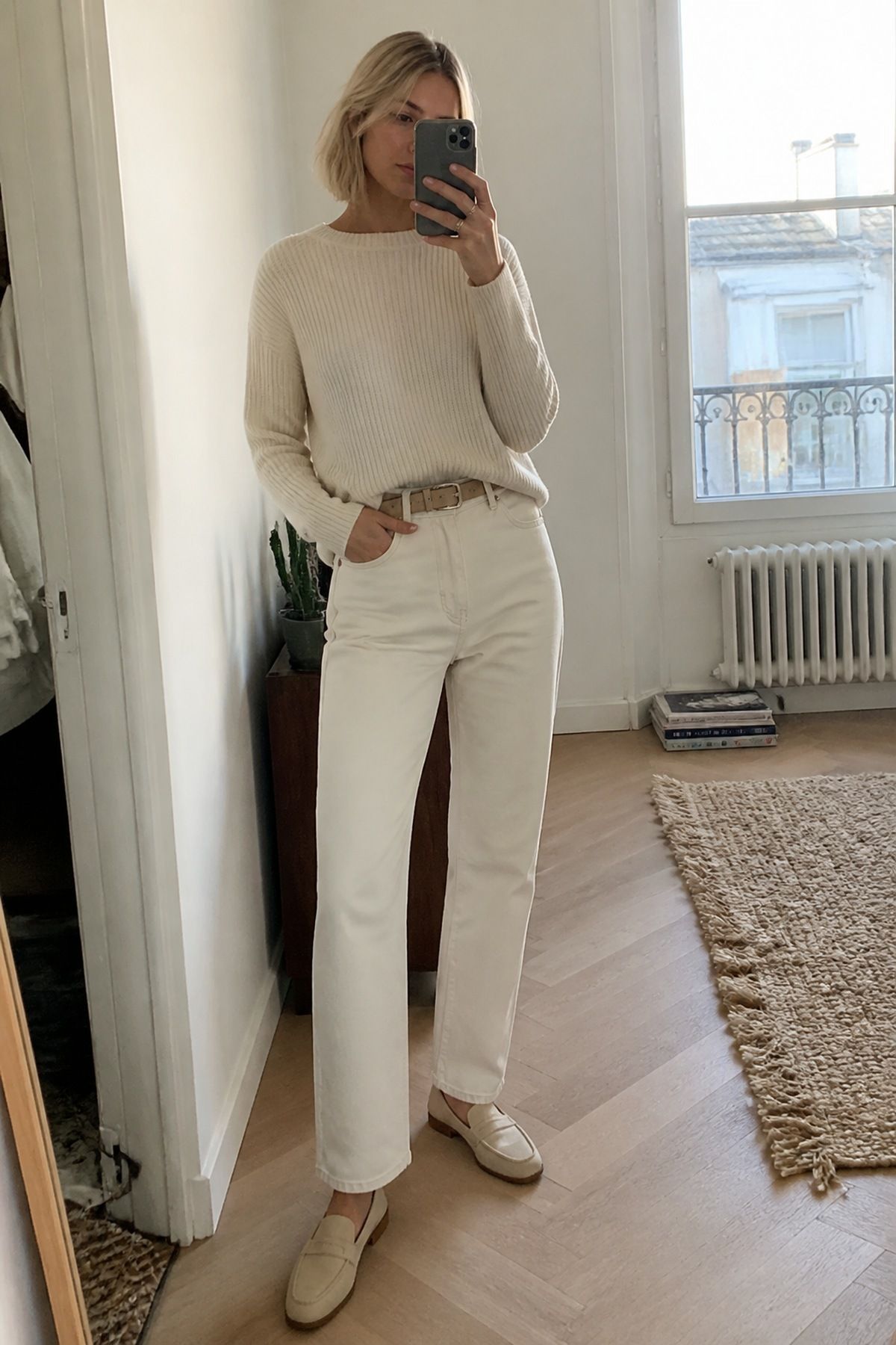 Woman wearing a cream sweater with ivory jeans, a monochrome outfit