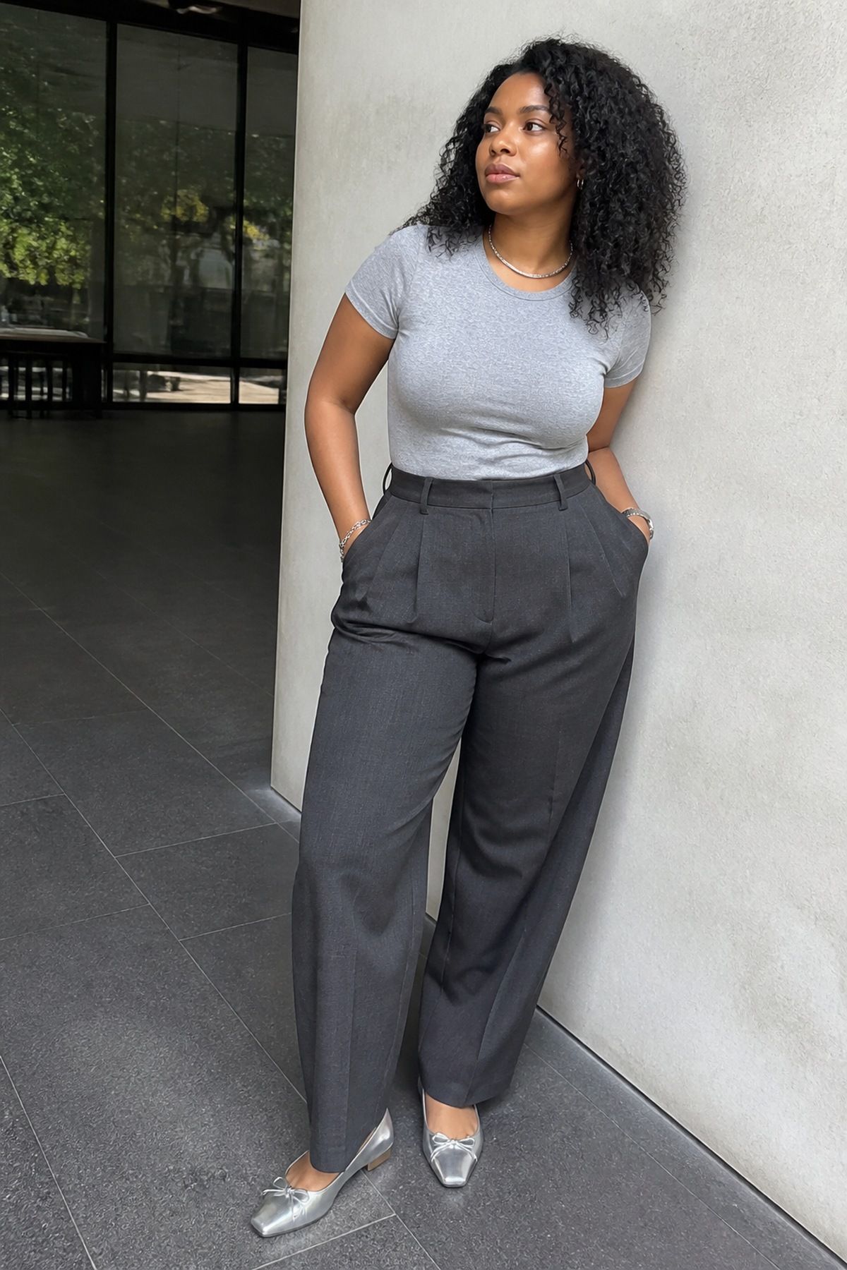 Woman wearing a gray tee with charcoal trousers, a monochrome outfit