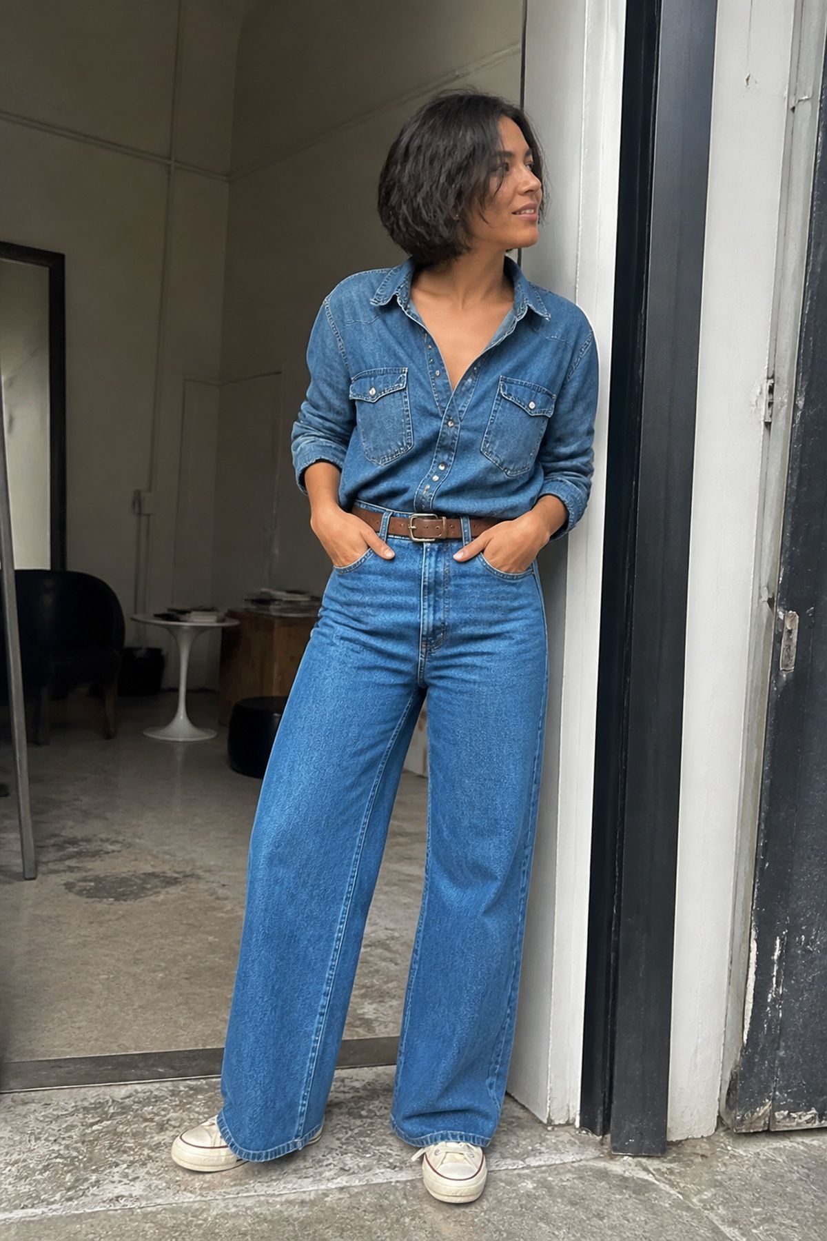 Woman wearing a denim shirt with wide-leg jeans, a monochrome outfit