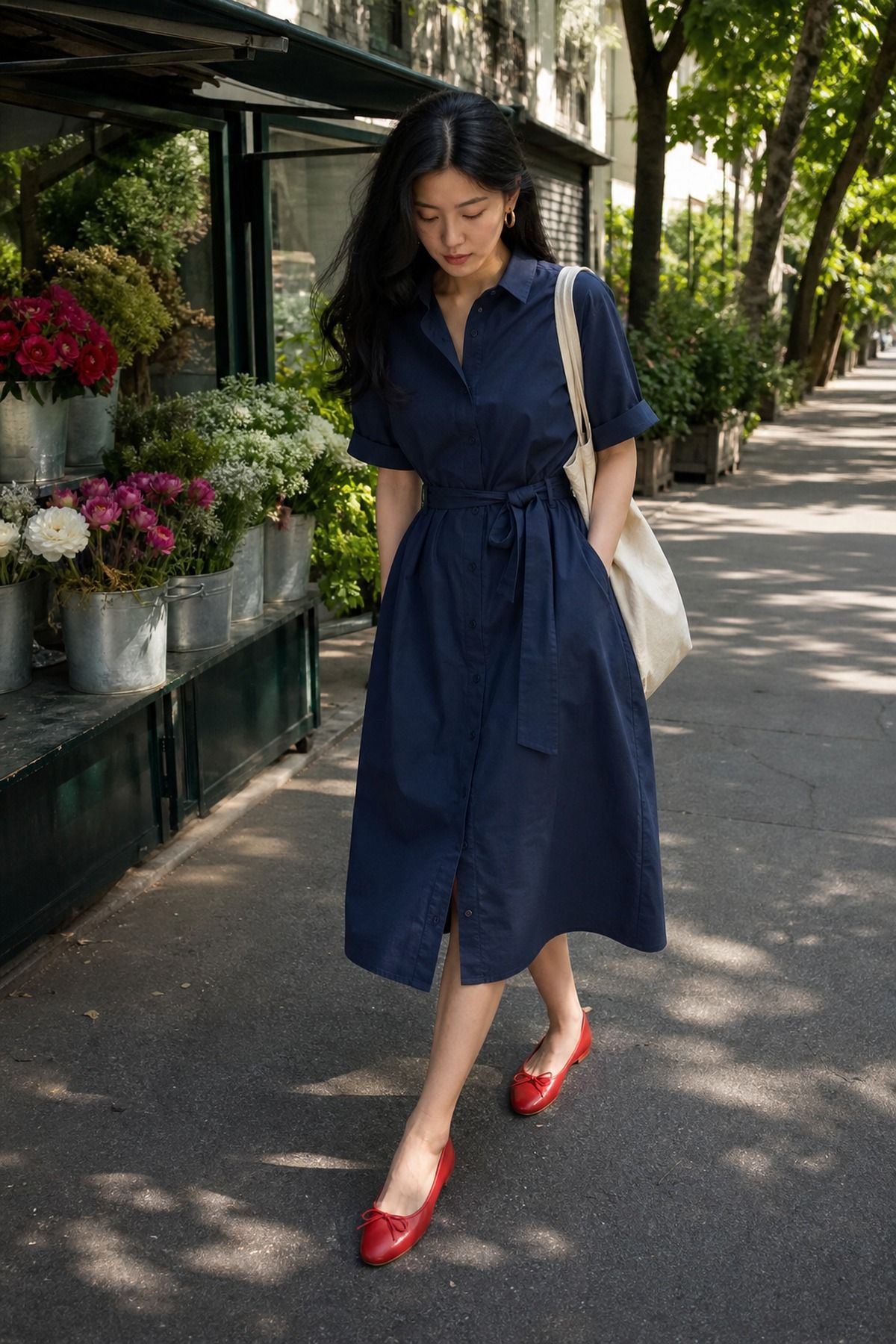 Woman wearing a navy shirt dress with red flats