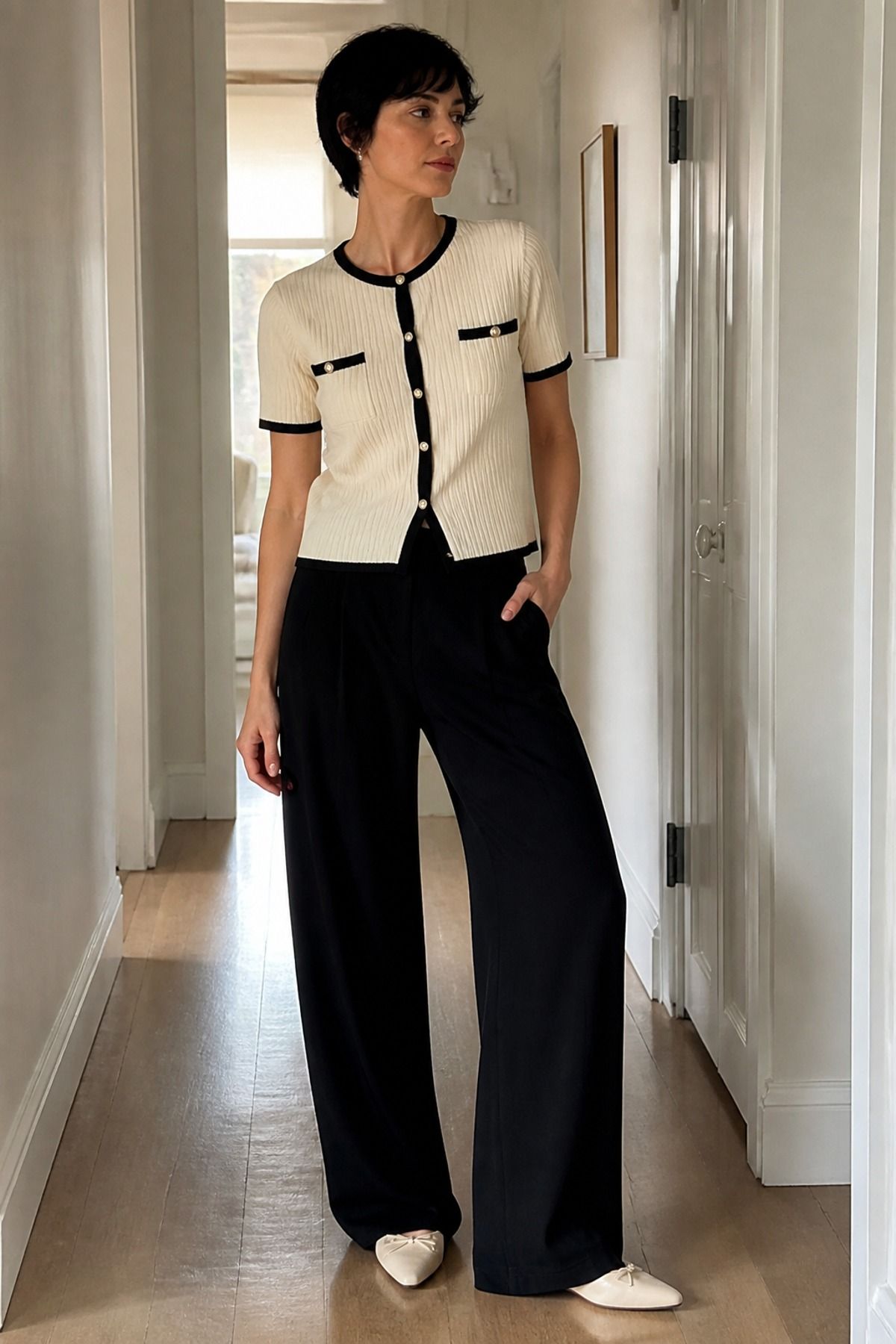 Woman wearing a black and cream matching separates, a neutral outfit