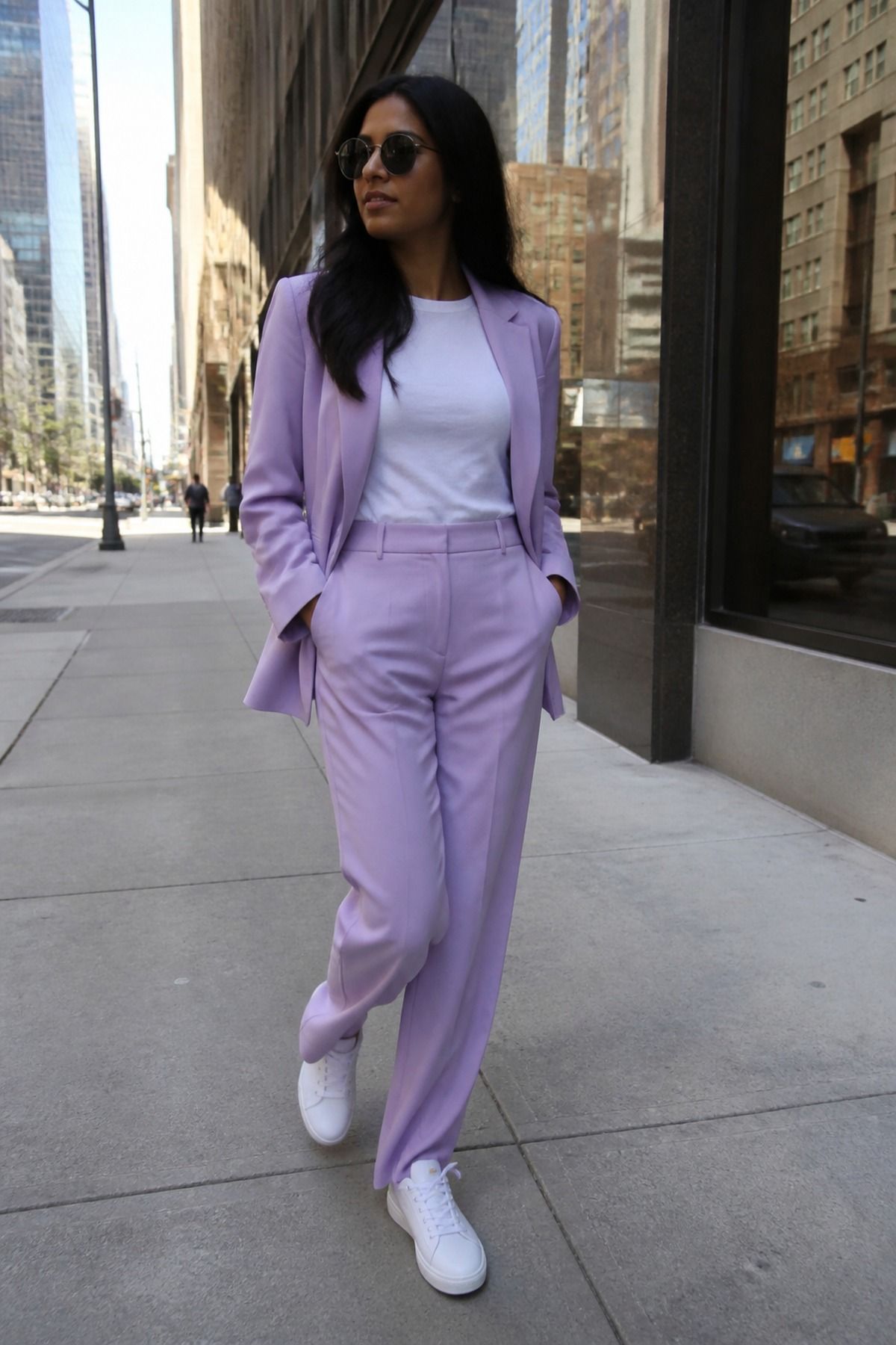 Woman wearing a pastel suit with a white tee
