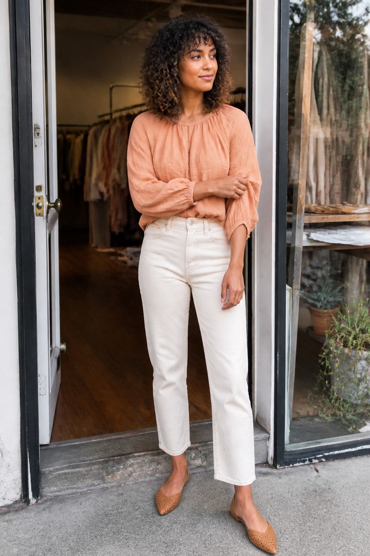 Woman wearing a peach blouse with ecru denim, a pastel outfit