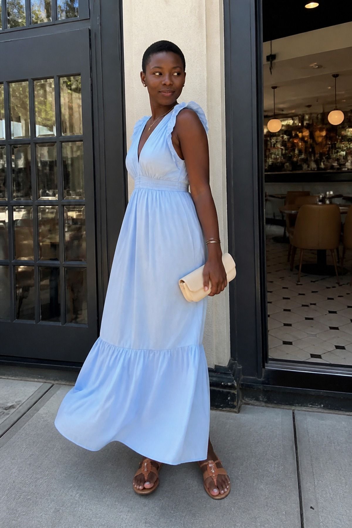 Woman wearing a pastel maxi dress with flat sandals