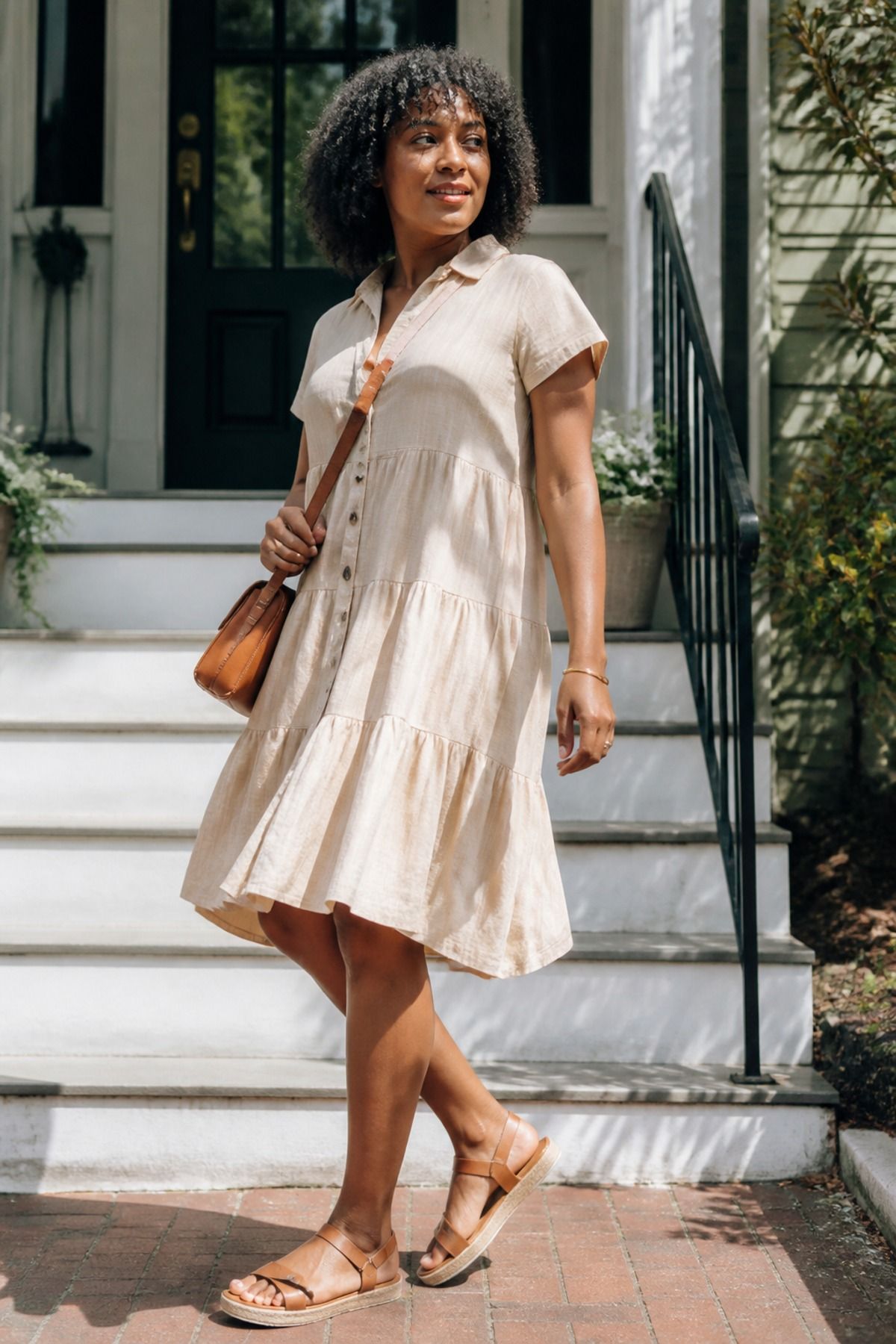 Woman wearing a tiered button dress with a crossbody bag, a postpartum outfit