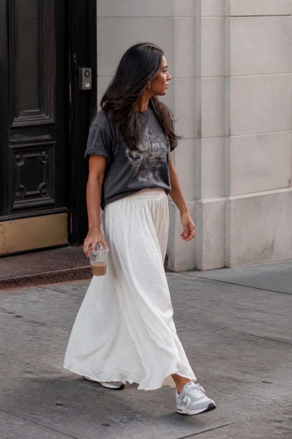 Woman wearing a maxi skirt with a relaxed graphic tee, a postpartum outfit