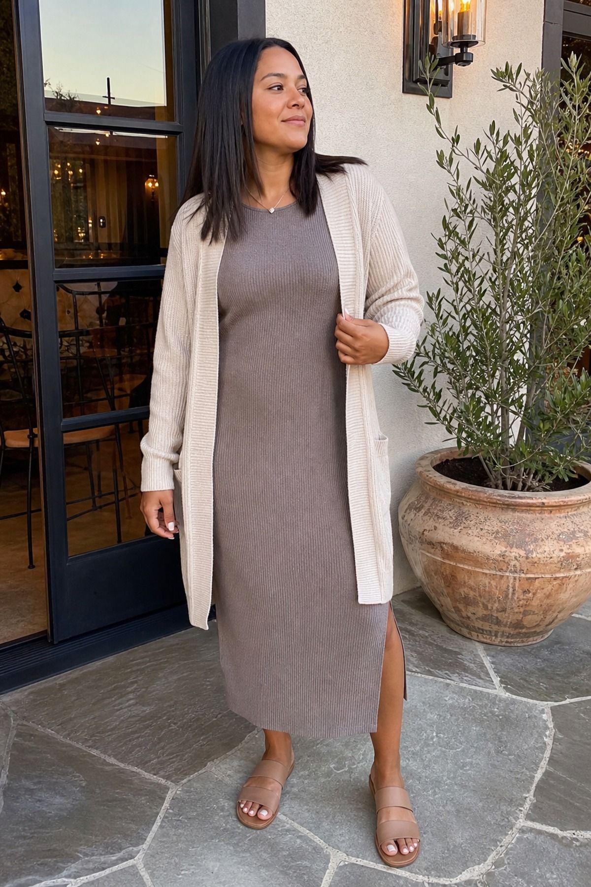 Woman wearing a midi dress with an open cardigan, a postpartum outfit