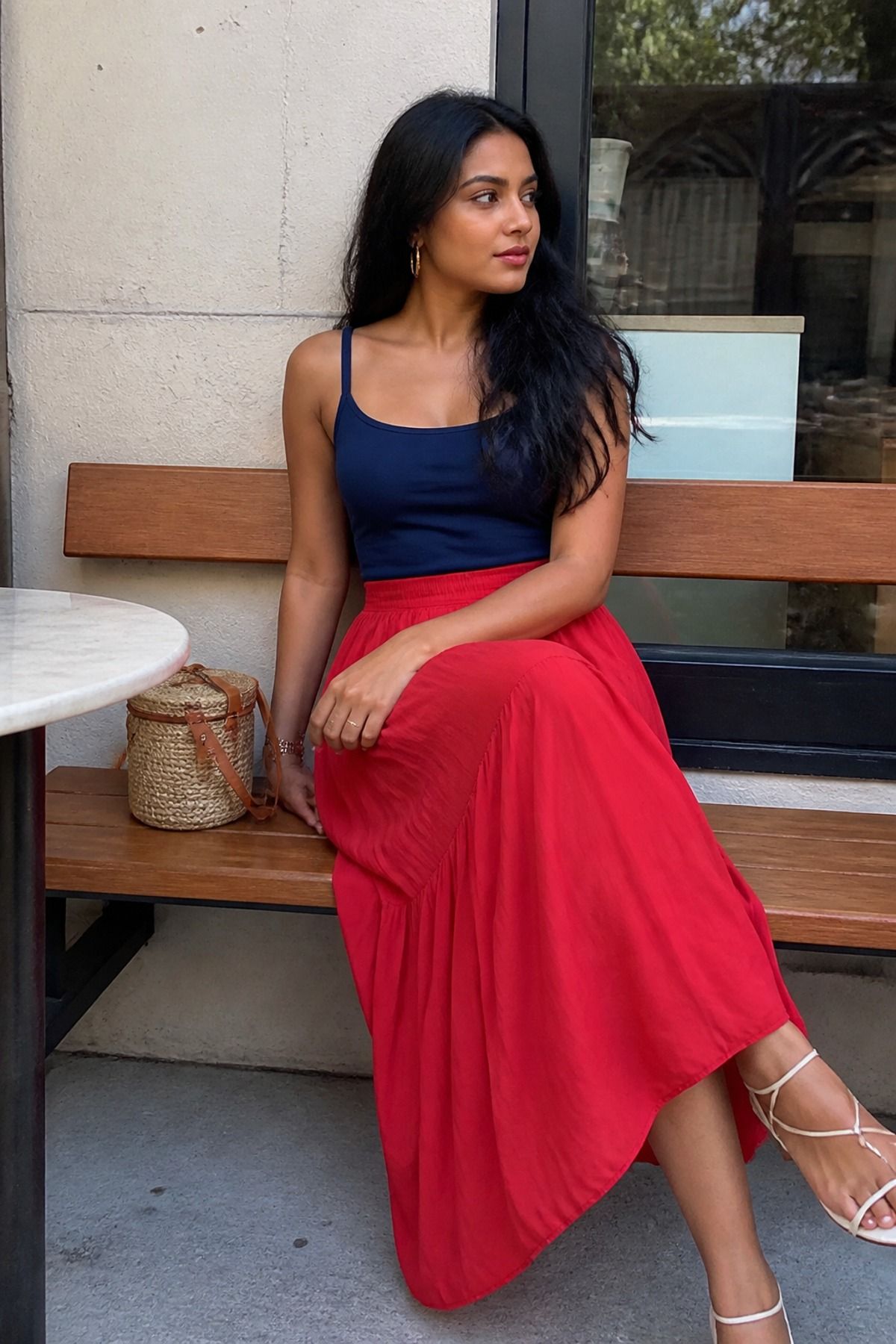 Woman wearing a red midi skirt with a navy tank, a Fourth of July outfit