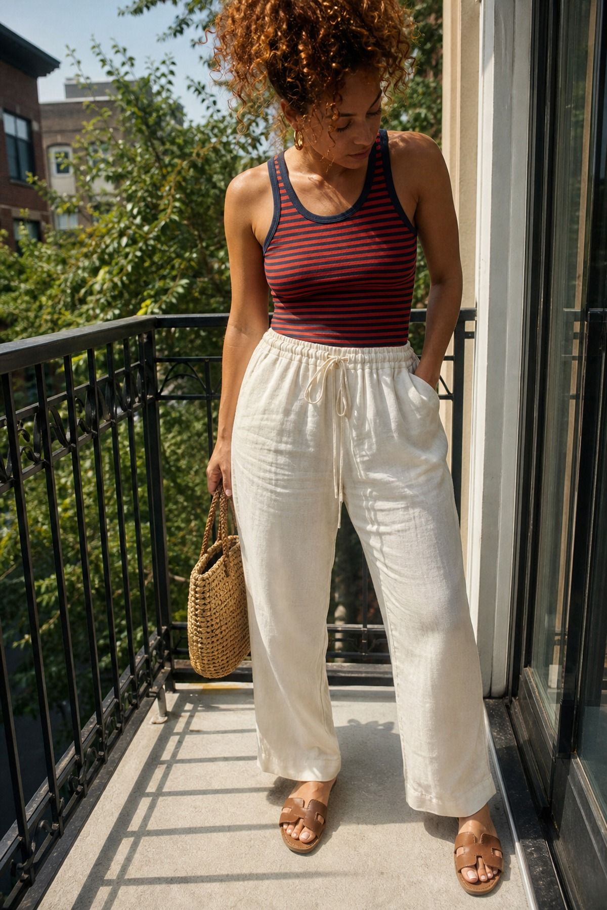 Woman wearing linen pants with a striped tank, a Fourth of July outfit
