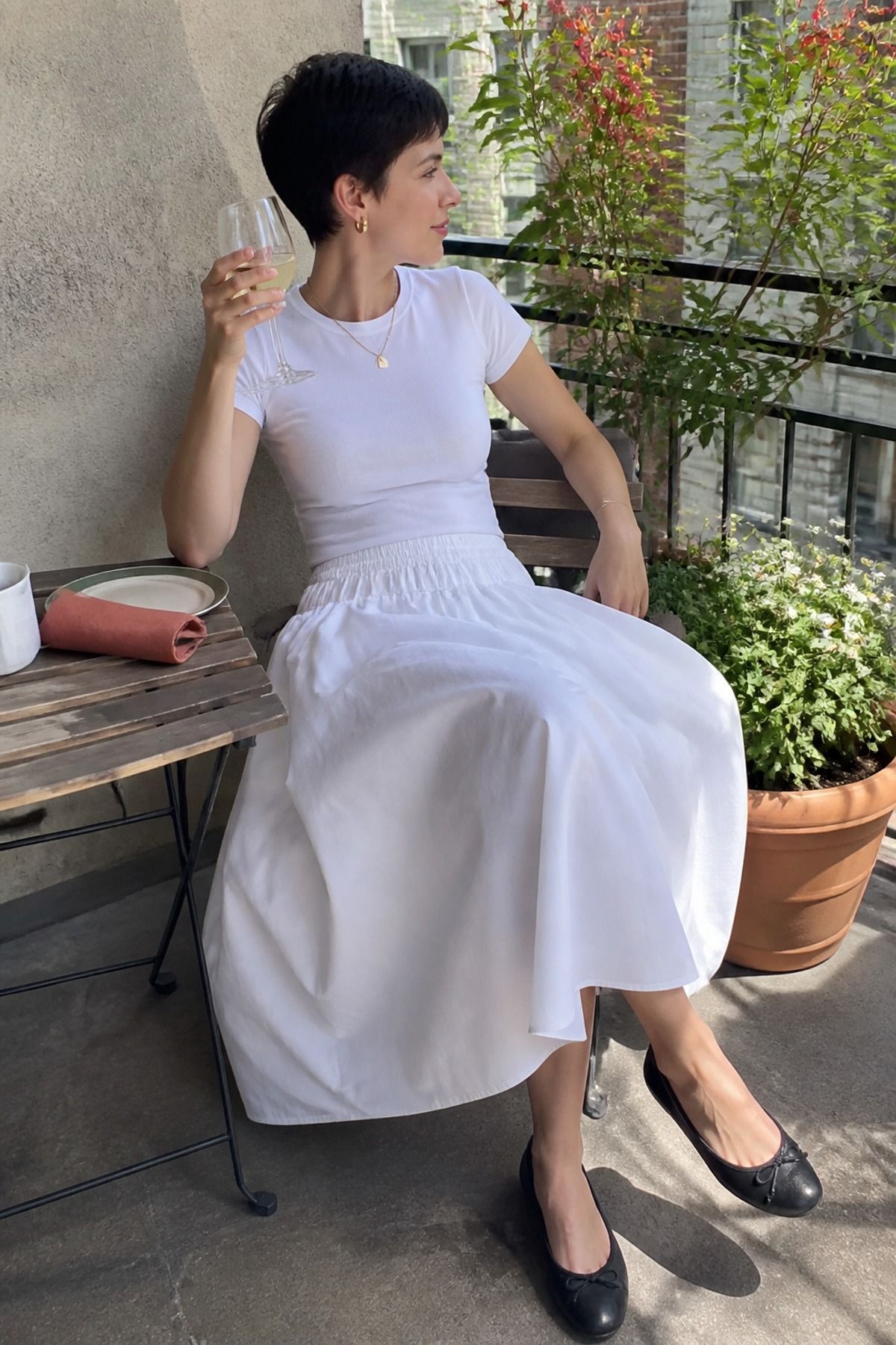 Woman wearing a cotton poplin skirt with a fitted tee, a Memorial Day outfit