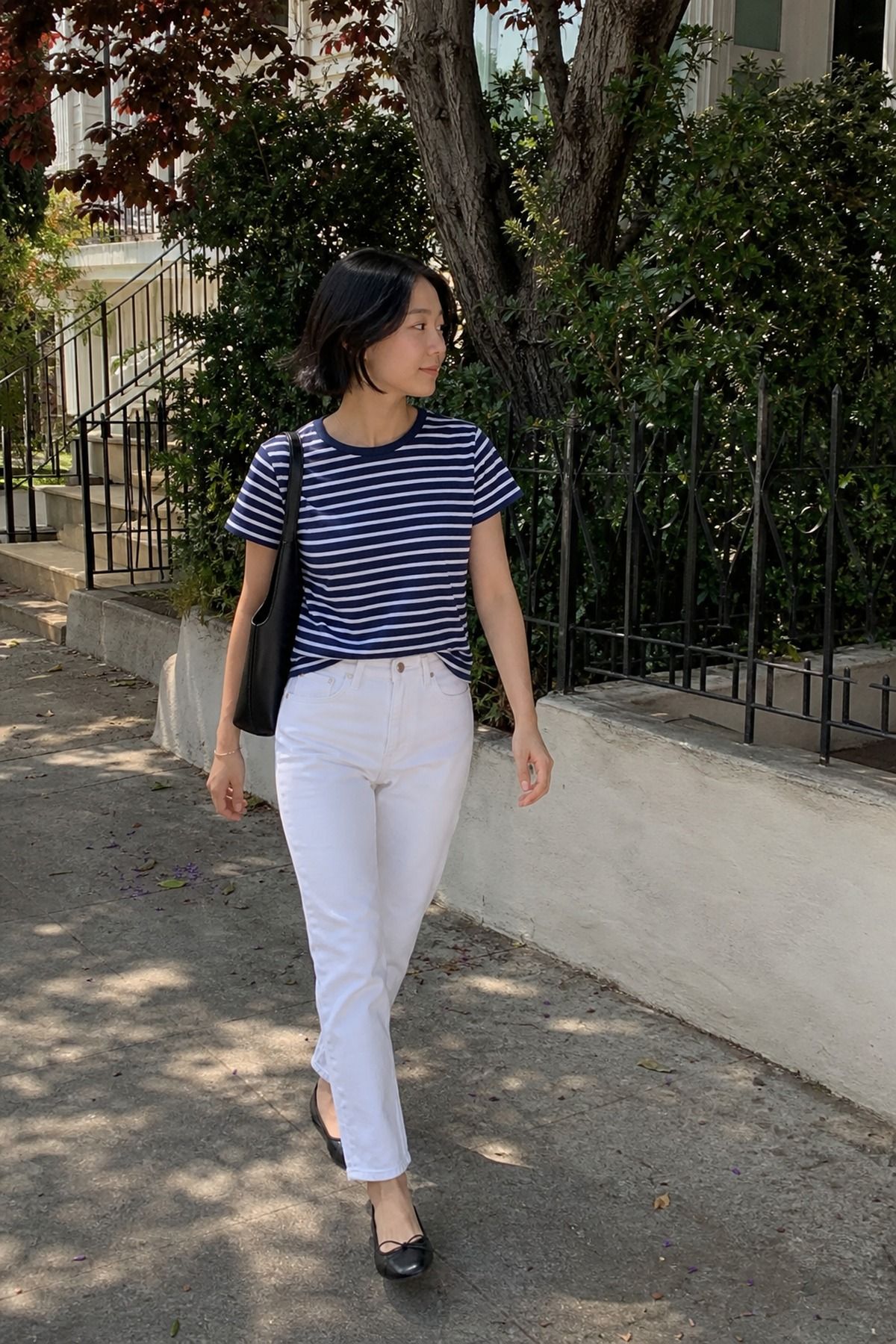 Woman wearing a striped tee, white jeans, and ballet flats, an Amazon casual outfit