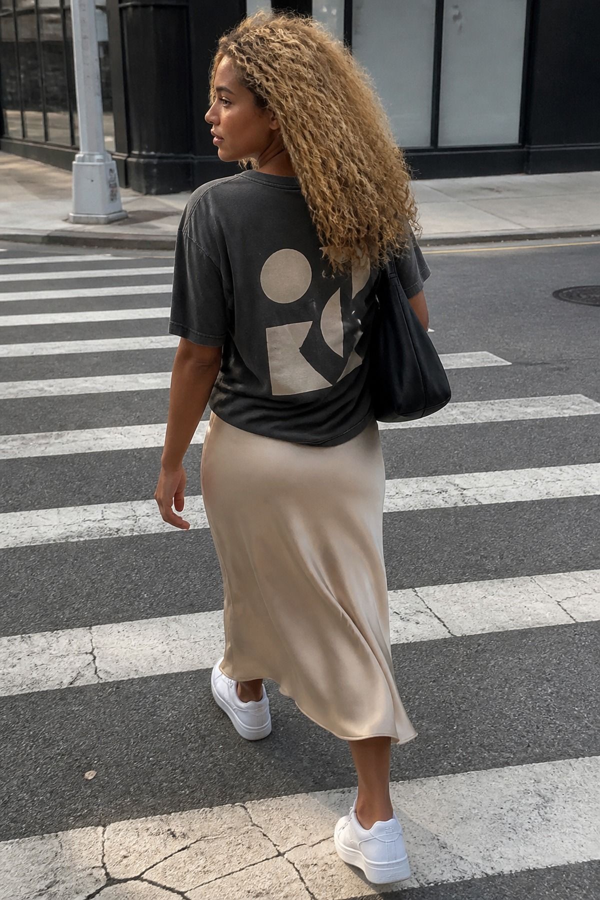 Woman wearing a slip skirt, graphic tee, and sneakers, an Amazon casual outfit