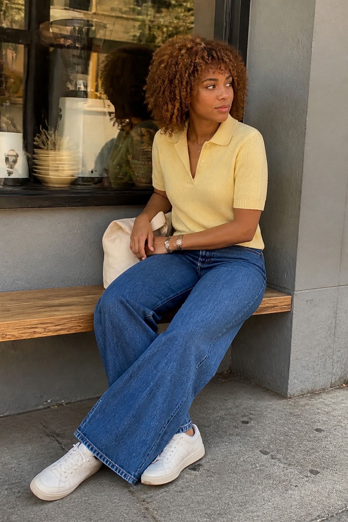 Woman wearing a knit polo, wide-leg jeans, and minimal sneakers, an Amazon casual outfit