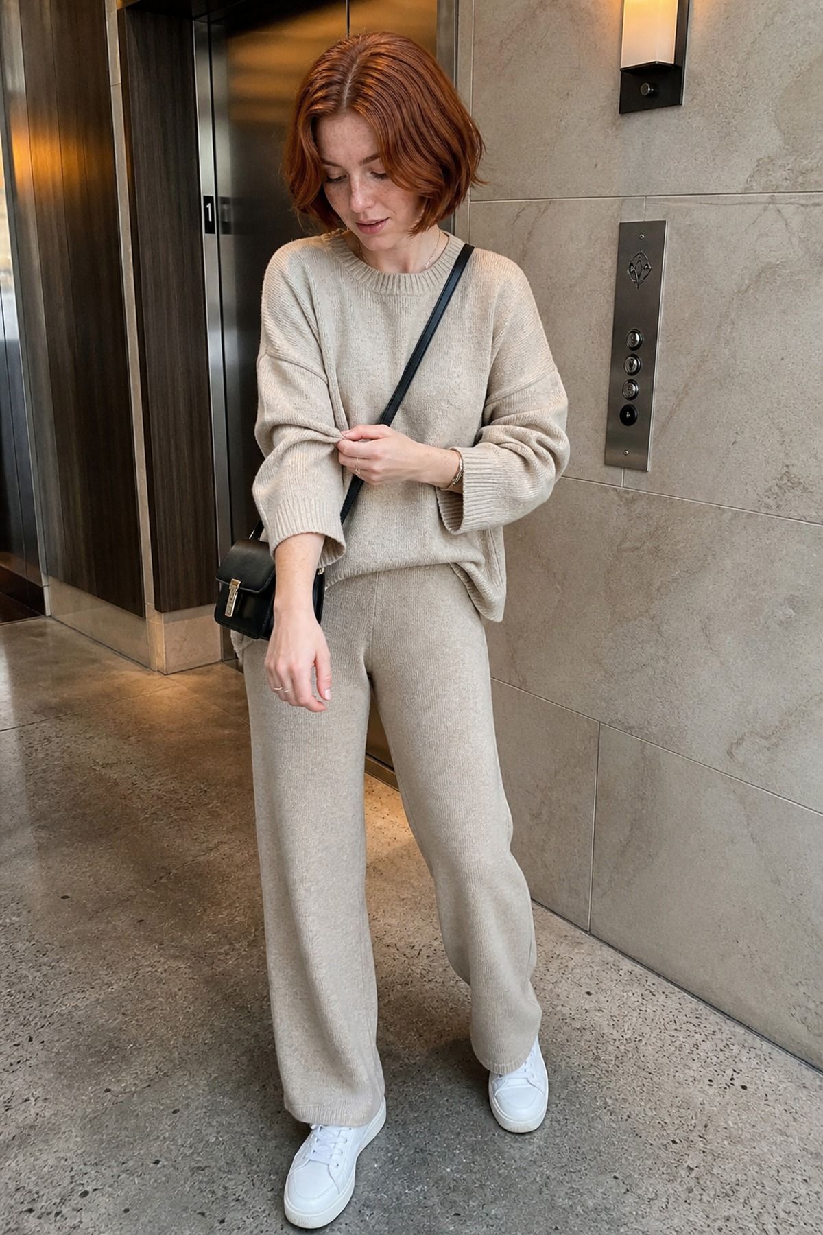 Woman wearing a matching knit set with white sneakers, an Amazon travel outfit