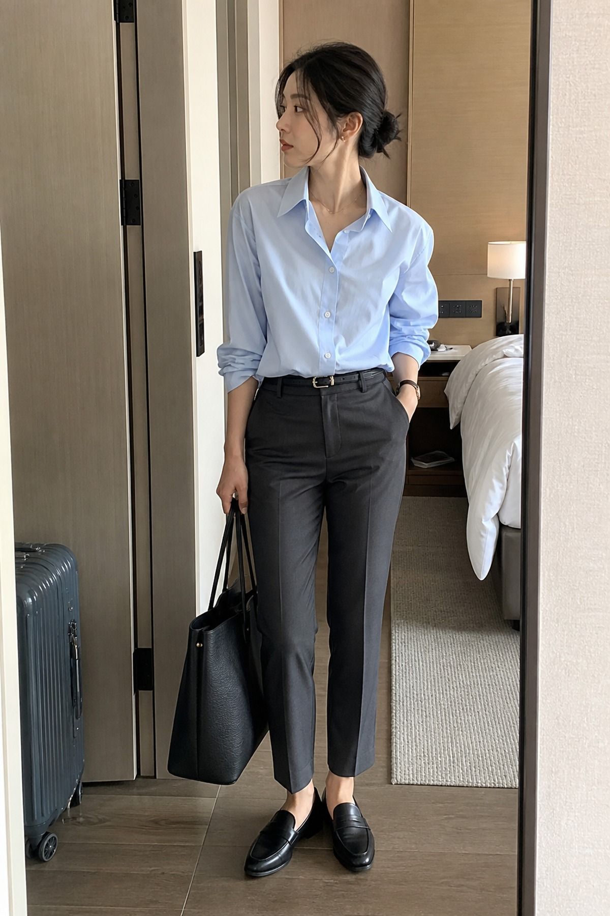 Woman wearing wrinkle-resistant ankle pants with a button-down, an Amazon travel outfit