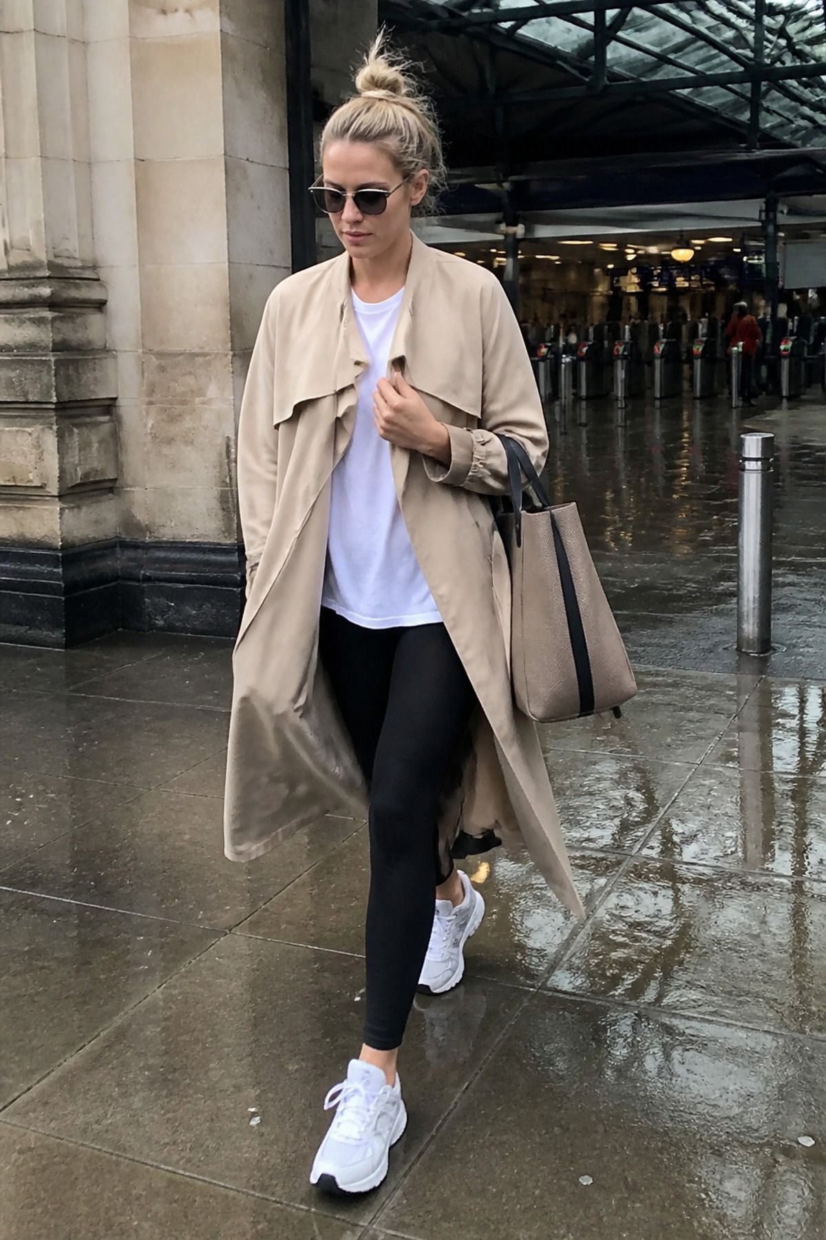 Woman wearing a soft trench with leggings and a long tee, an Amazon travel outfit