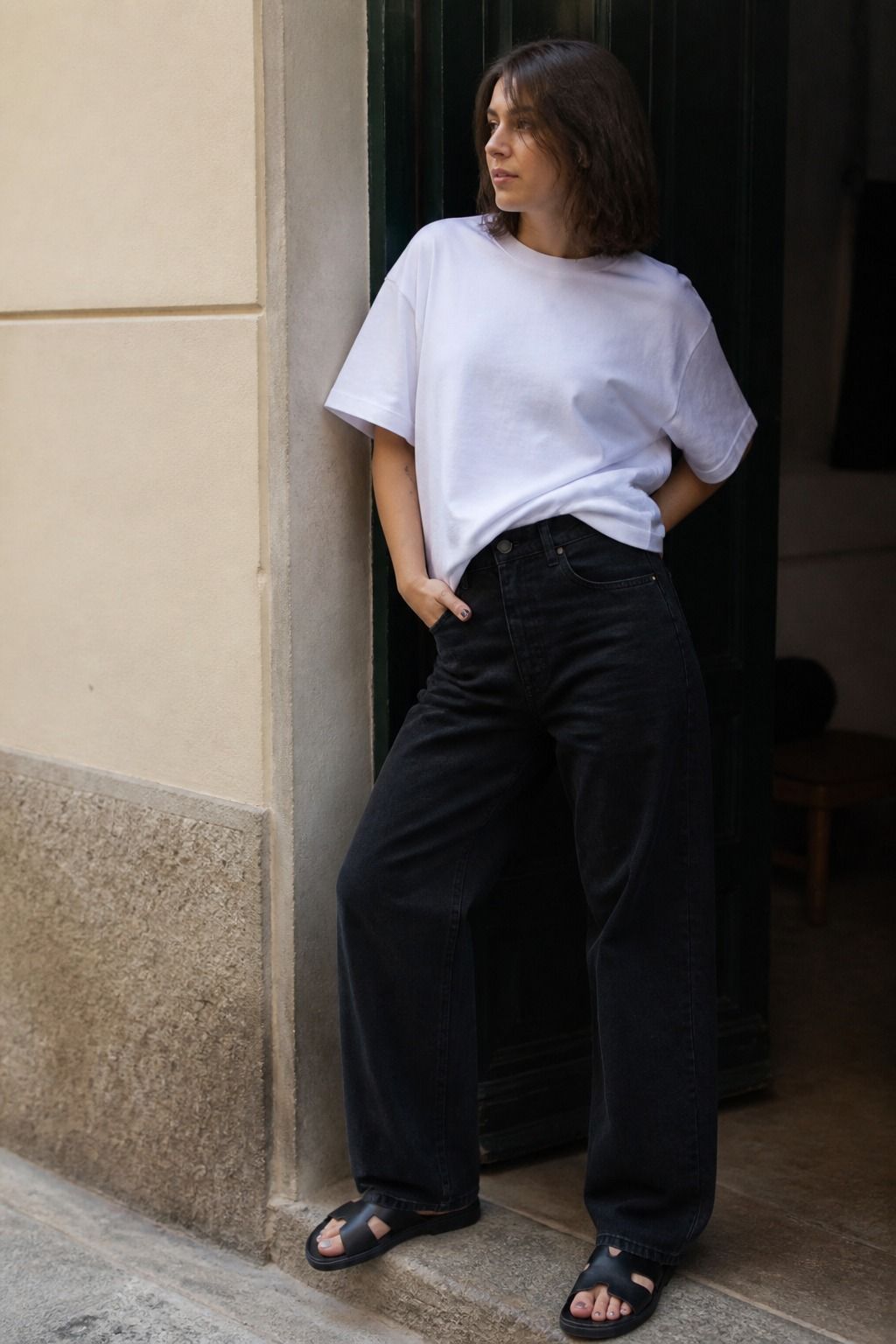 Woman styling a heavyweight white T-shirt with black jeans