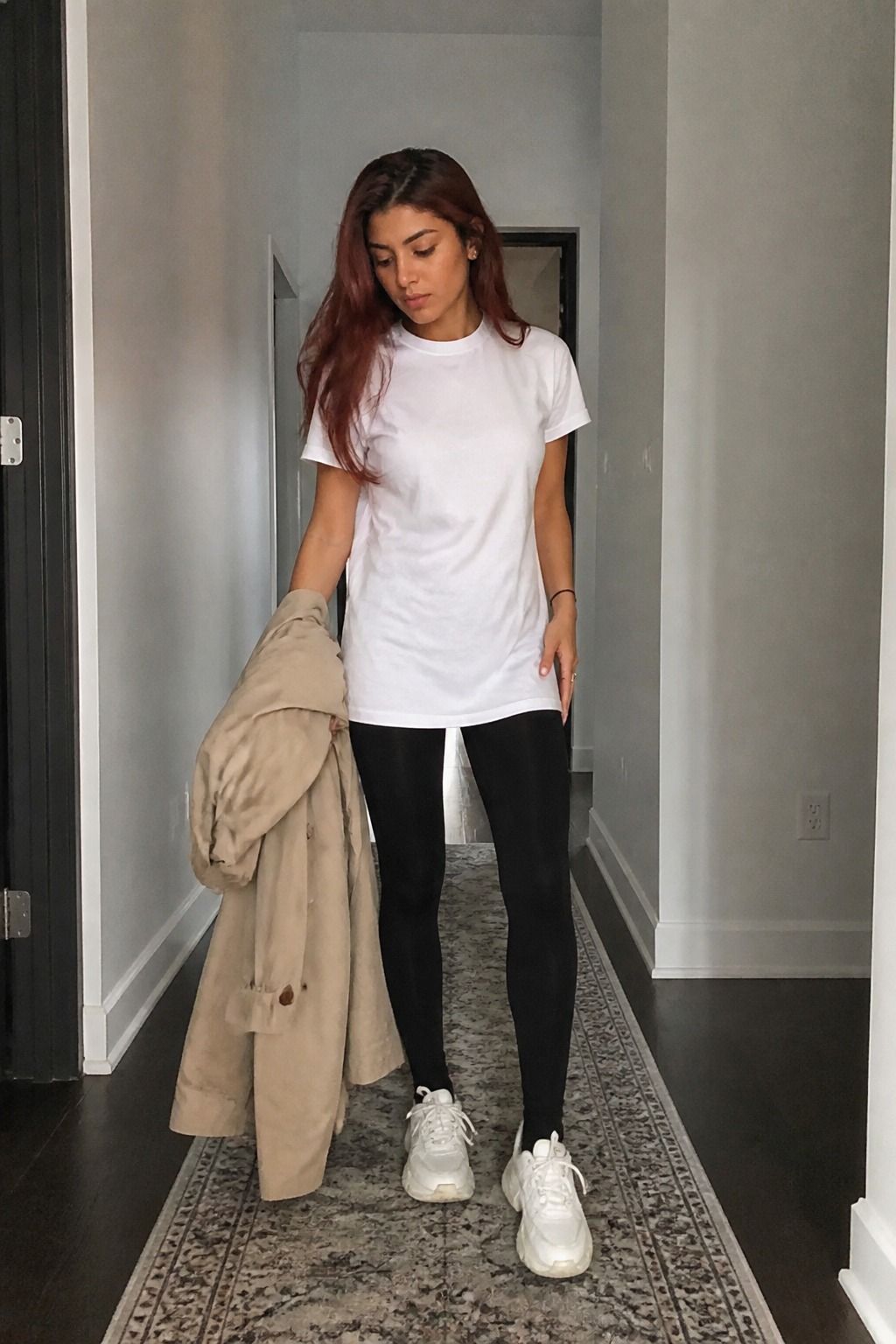 Woman wearing a longline white T-shirt with black leggings