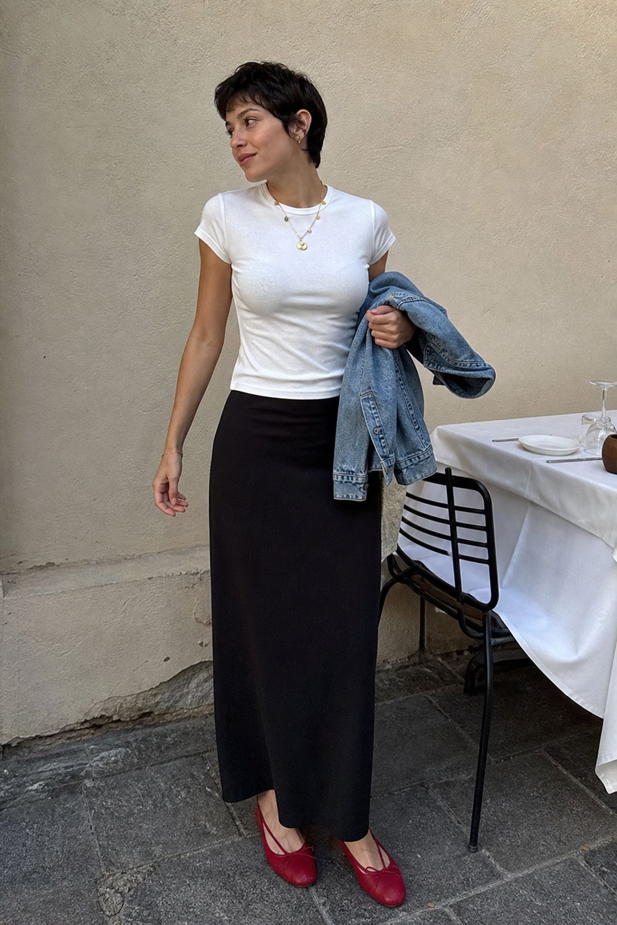 Woman wearing a maxi skirt with a fitted baby tee, a birthday dinner outfit
