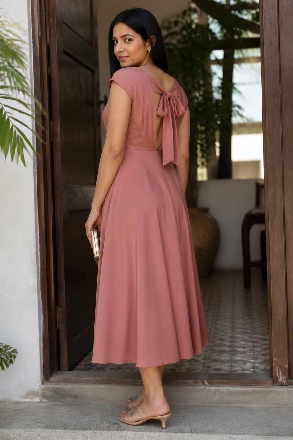 Woman wearing a soft a-line dress with a surprise back detail, a bridal shower guest outfit