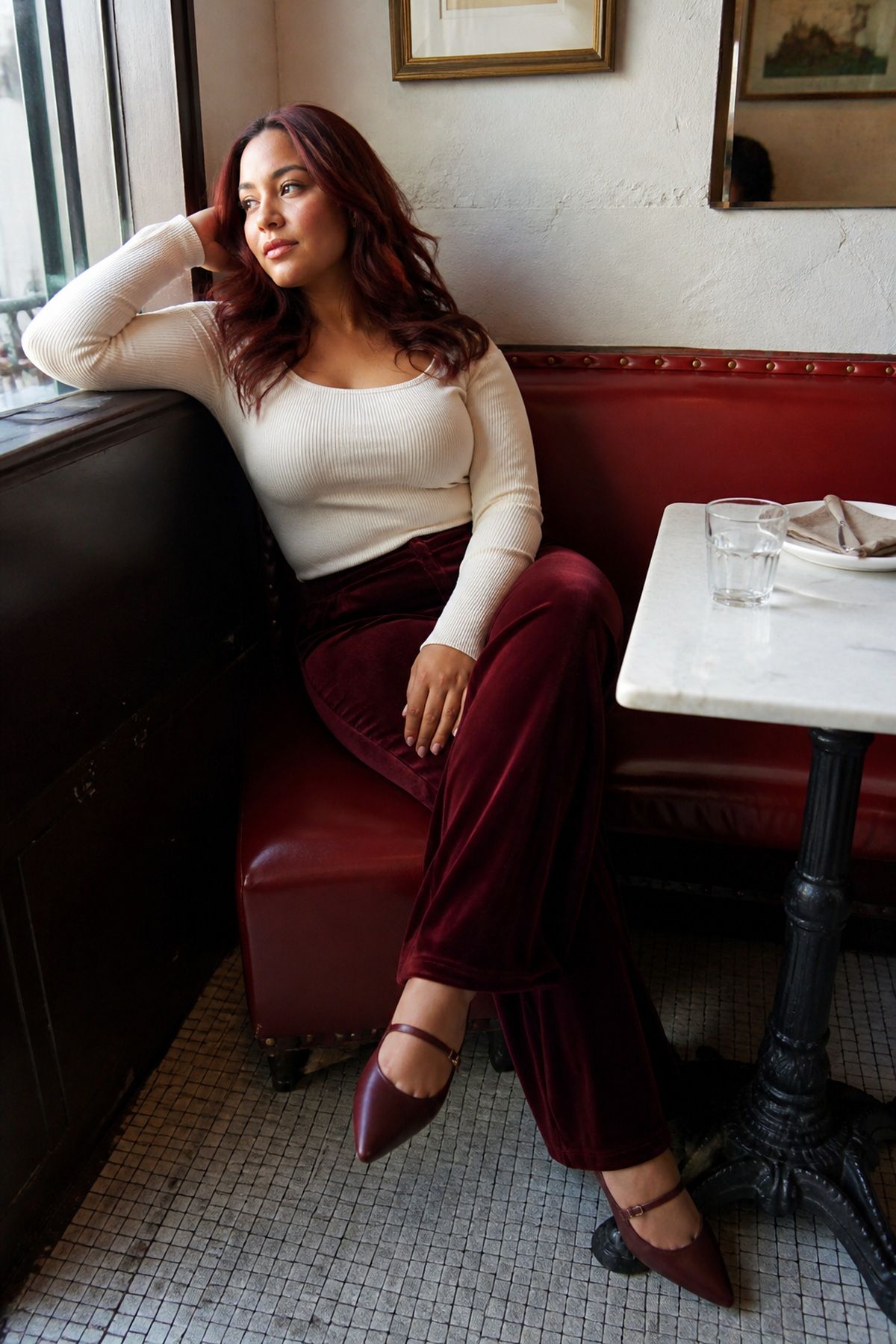 Woman wearing velvet pants with a fine knit top, a casual Christmas Eve outfit