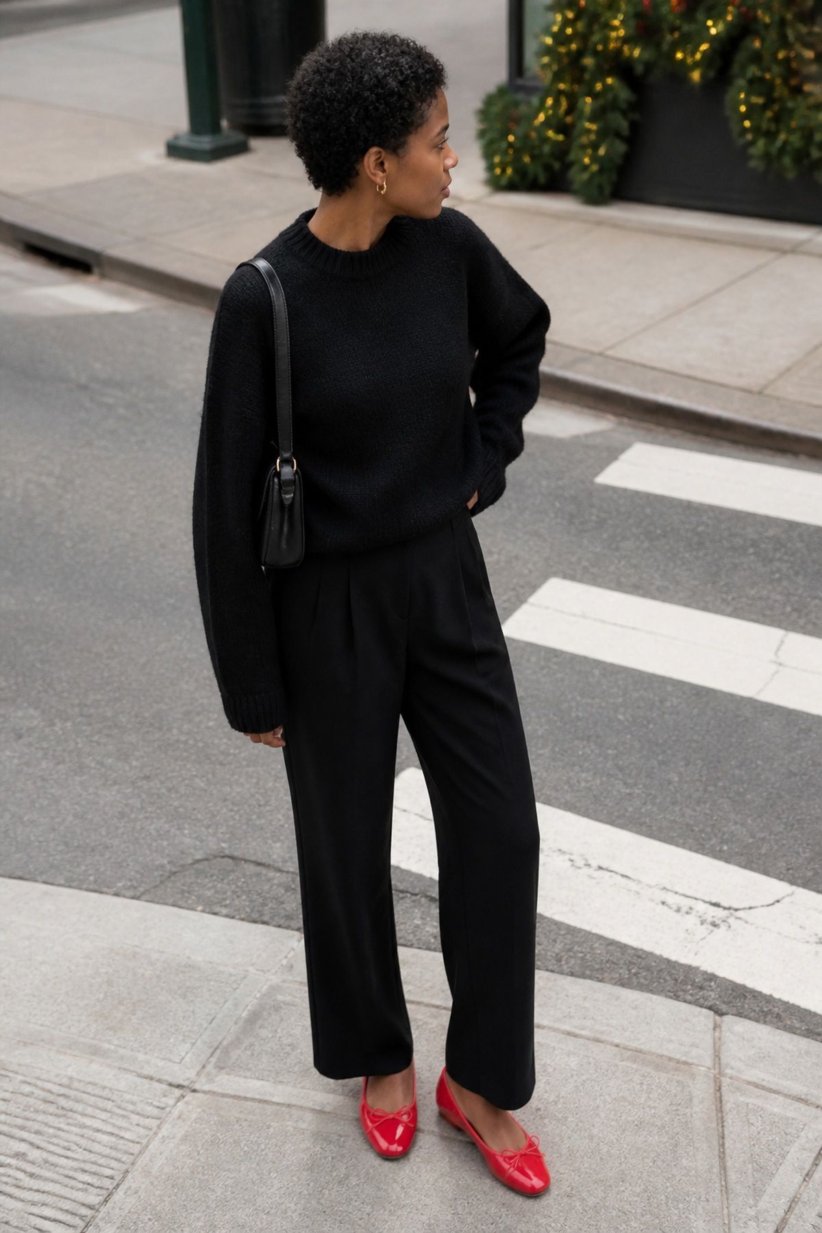 Woman wearing red flats with an all-black outfit, a casual Christmas Eve outfit