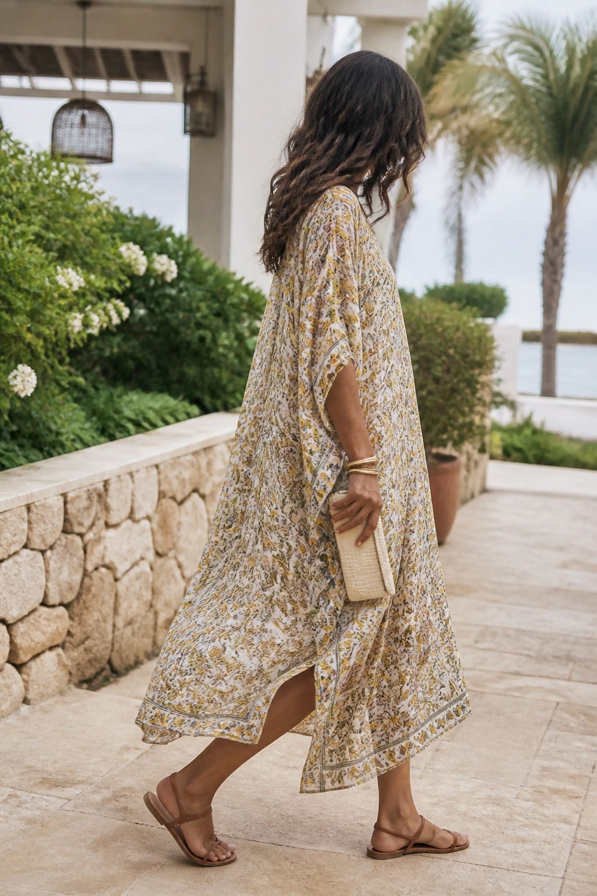 breezy caftan dress with flat leather sandals casual wedding guest outfit