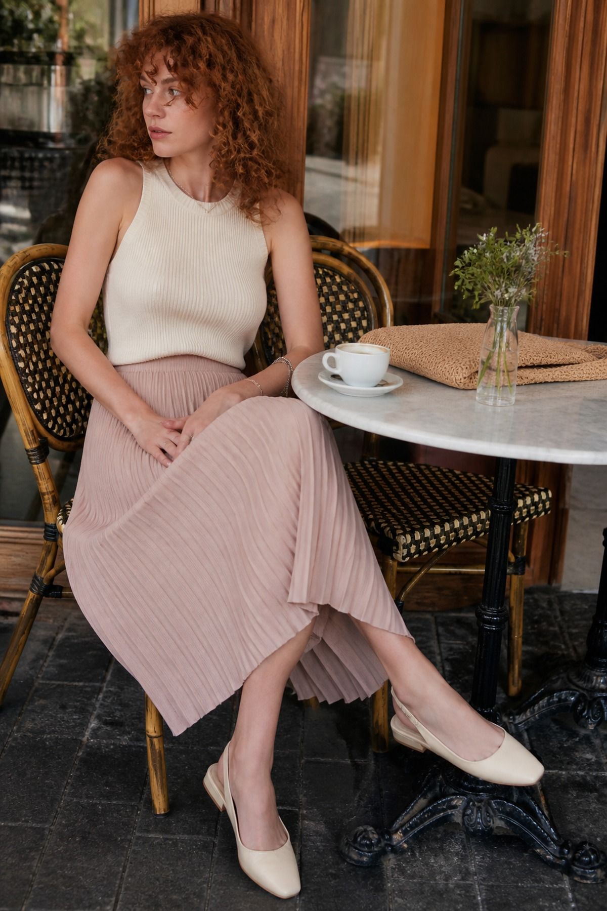 pleated midi skirt with a knit tank casual wedding guest outfit