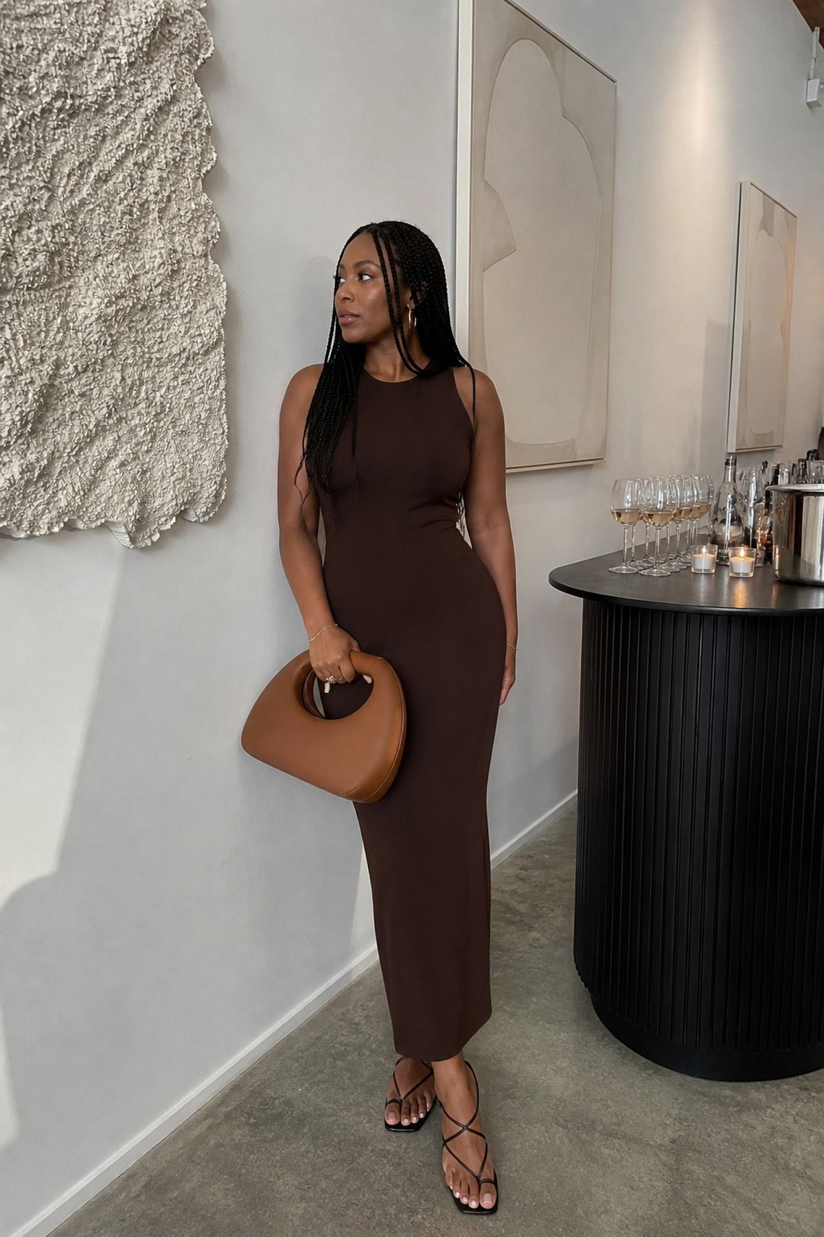 minimal column dress with a statement bag casual wedding guest outfit