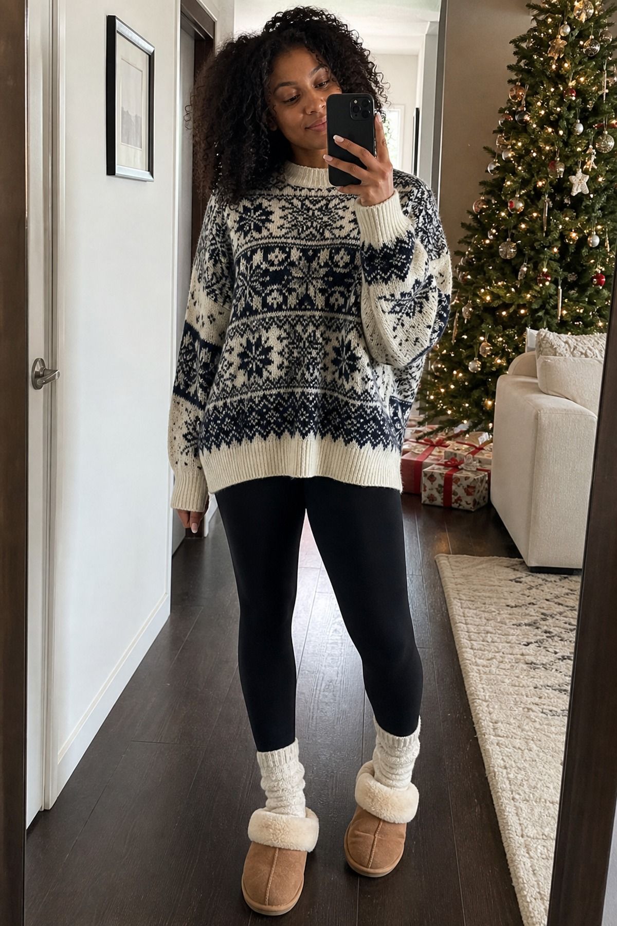 Woman wearing leggings with an oversized fair isle sweater, a Christmas morning outfit