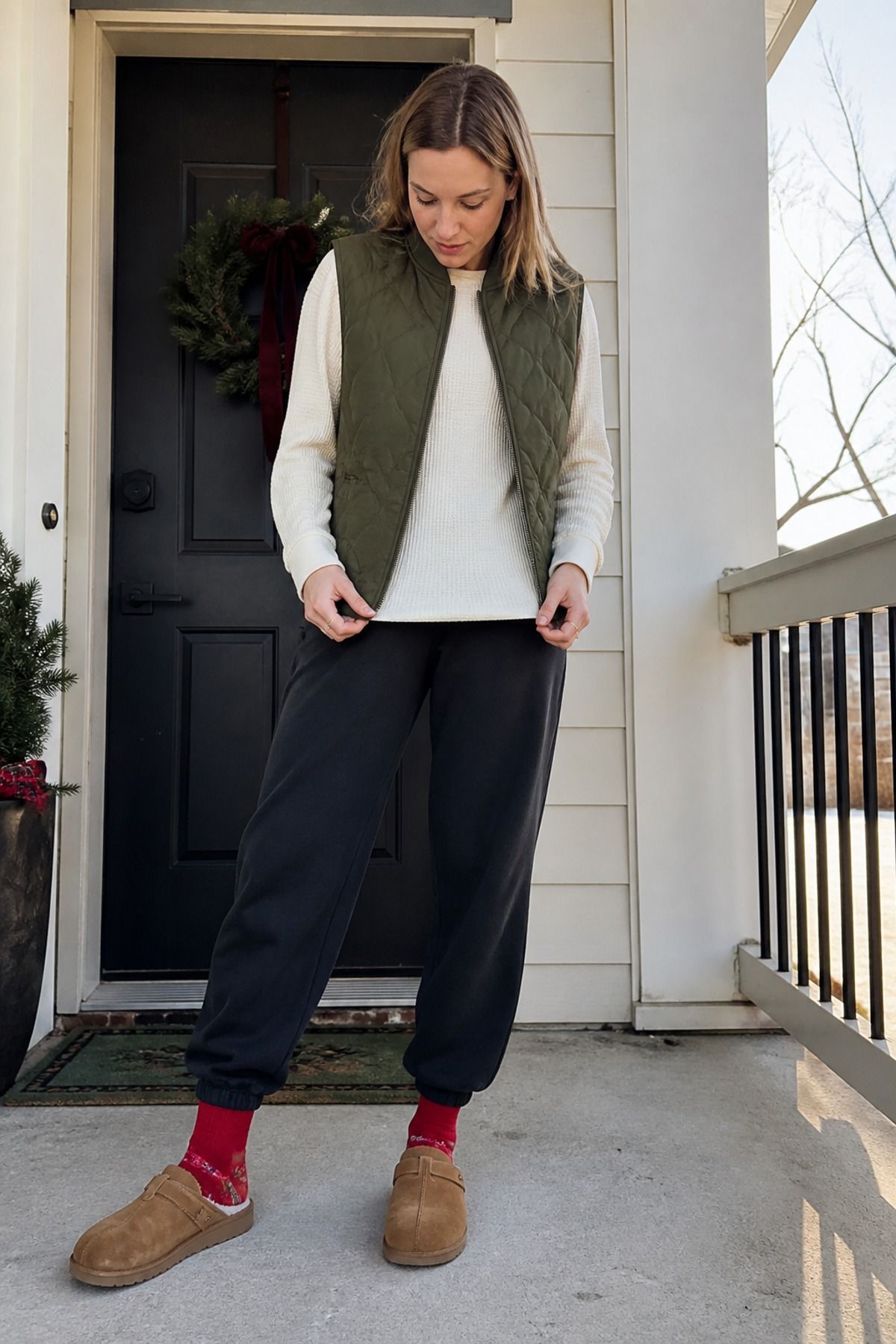 Woman wearing a thermal top with a quilted vest, a Christmas morning outfit