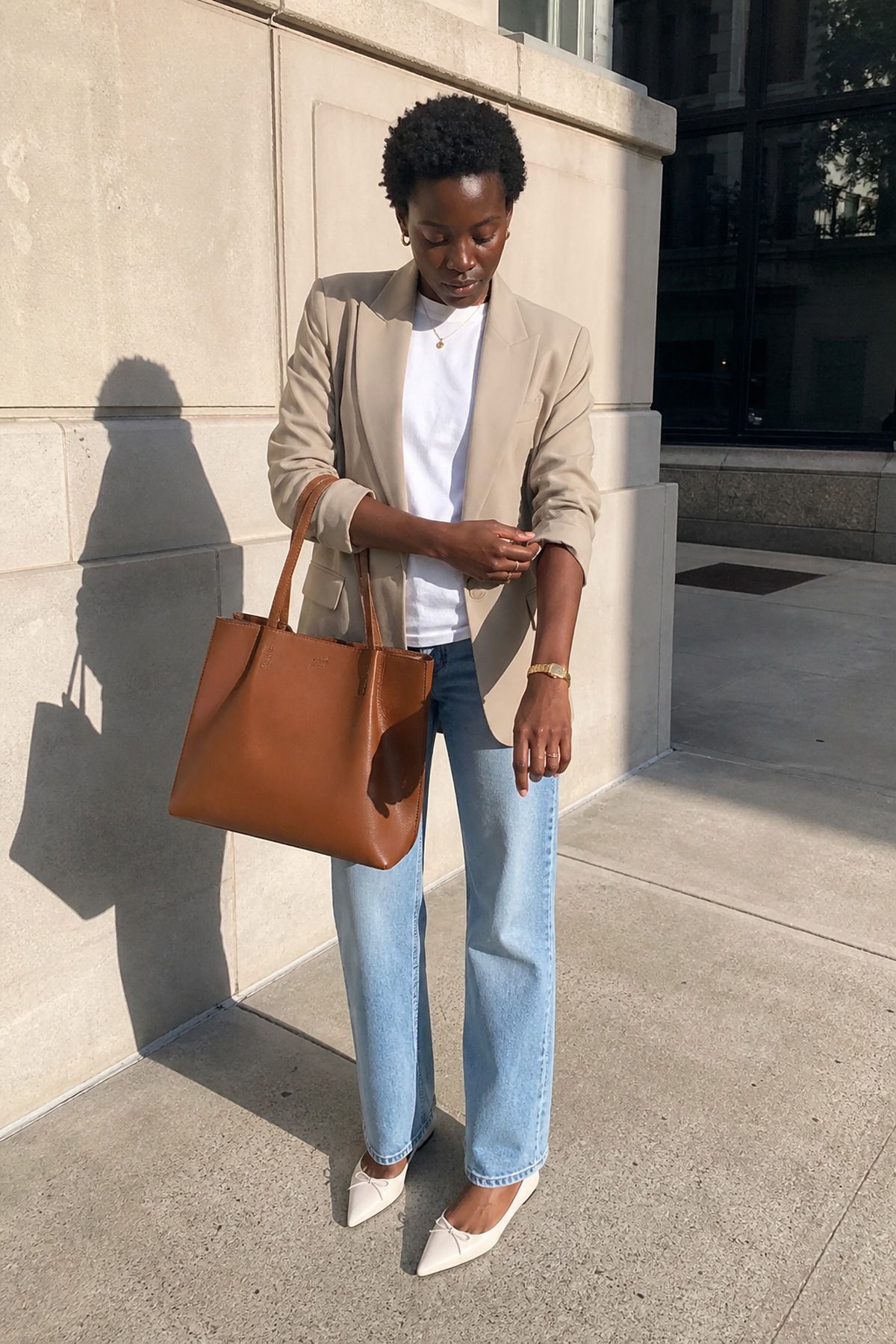 Woman wearing an a simple blazer with straight jeans, a Target outfit