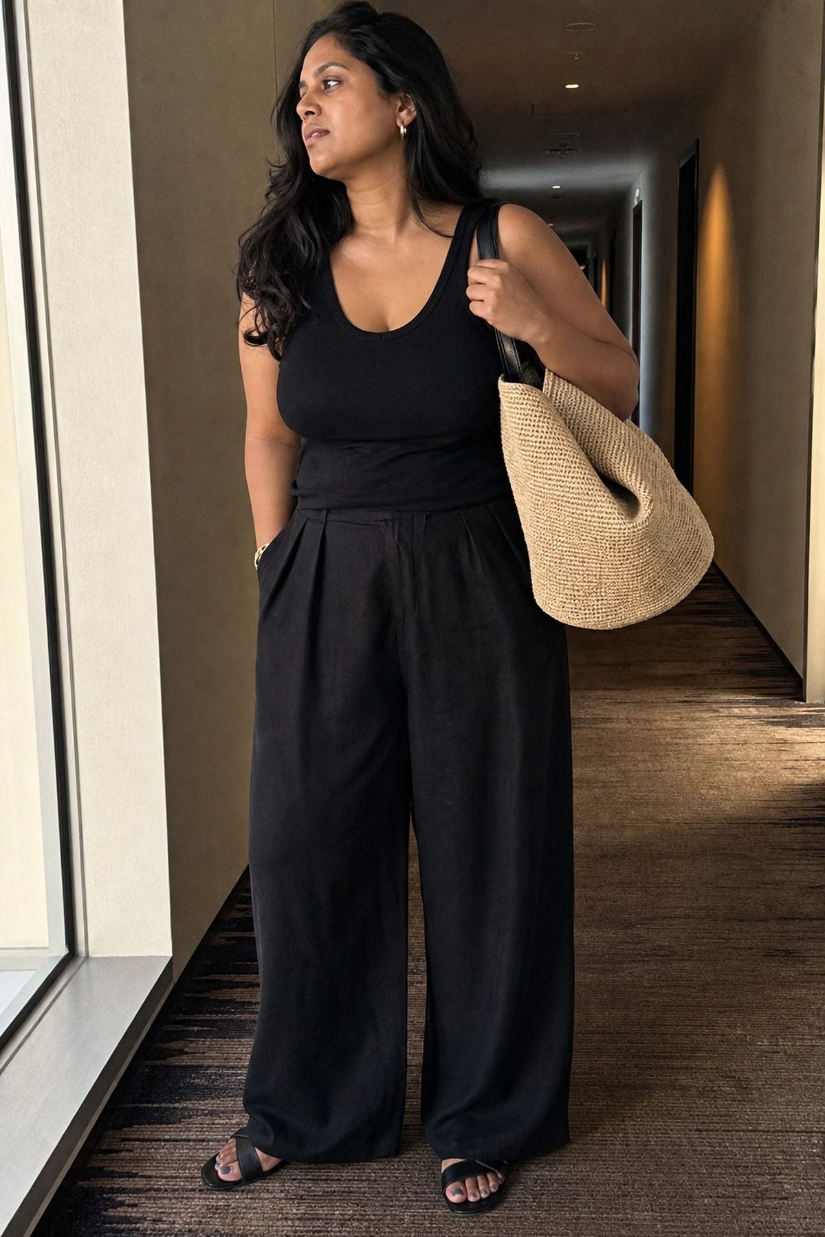 Woman wearing monochrome black basics with a raffia bag, a Target outfit