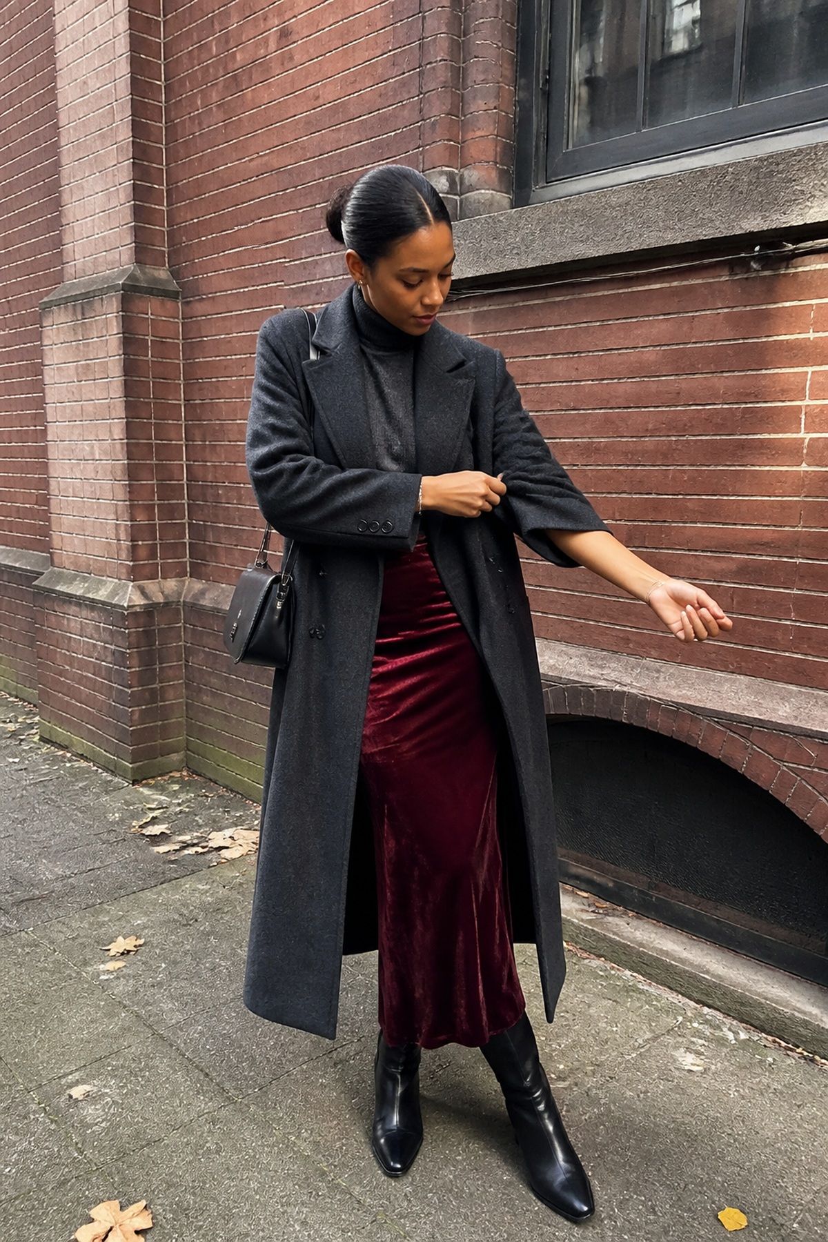 Woman wearing a burgundy velvet with charcoal layers, a winter family photo outfit