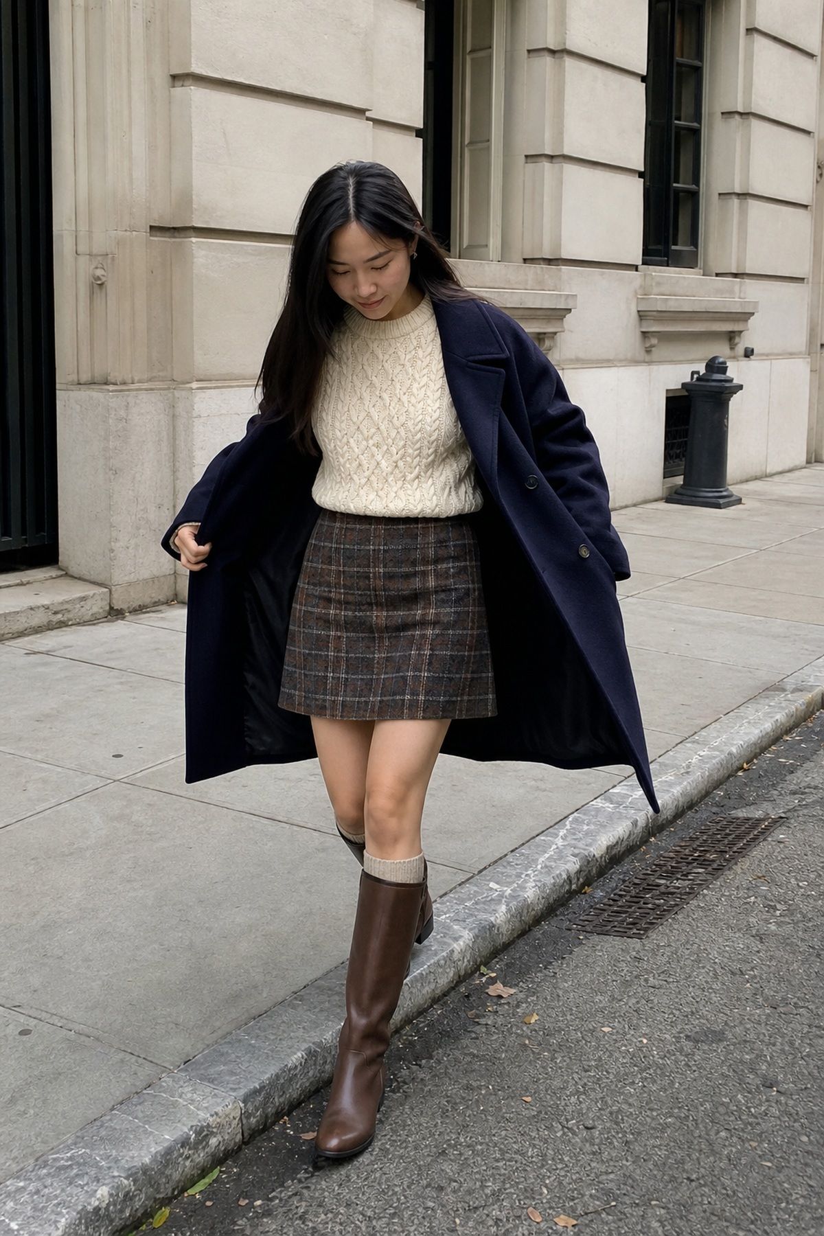 Woman wearing a plaid skirt, fisherman sweaters, and tall boots, a winter family photo outfit